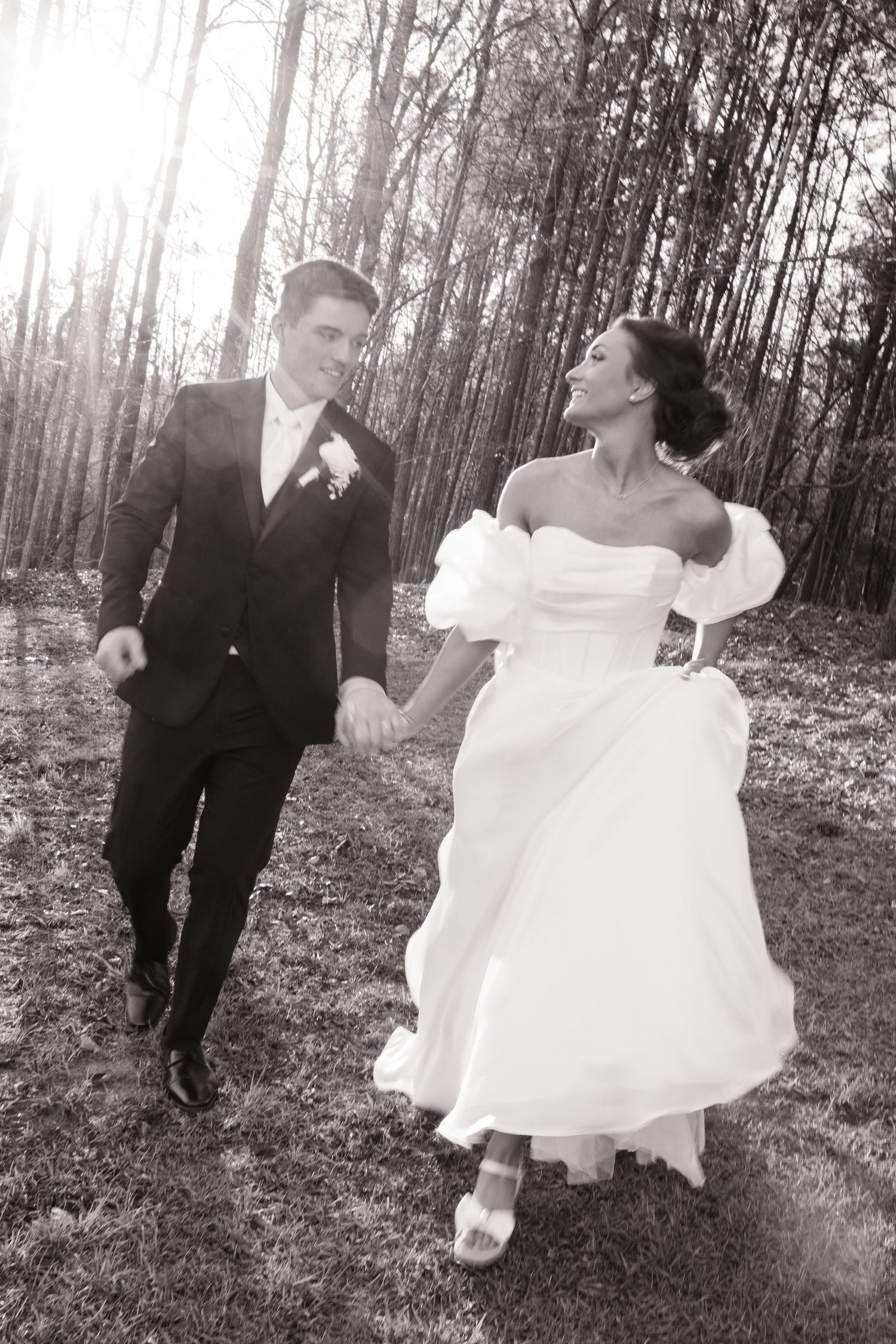 Black and white wedding photo sequence showing couple dancing playfully in a wooded setting.