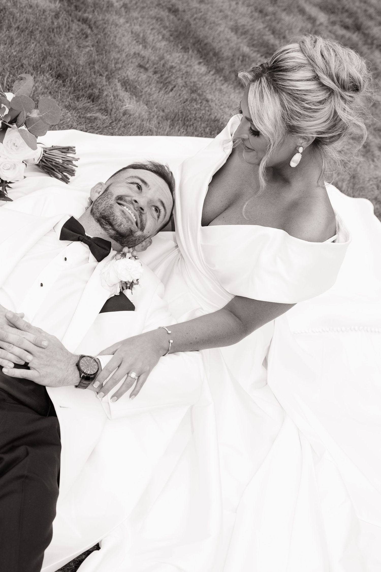 A romantic black and white photo series showing tender moments between a couple in wedding attire on their special day.