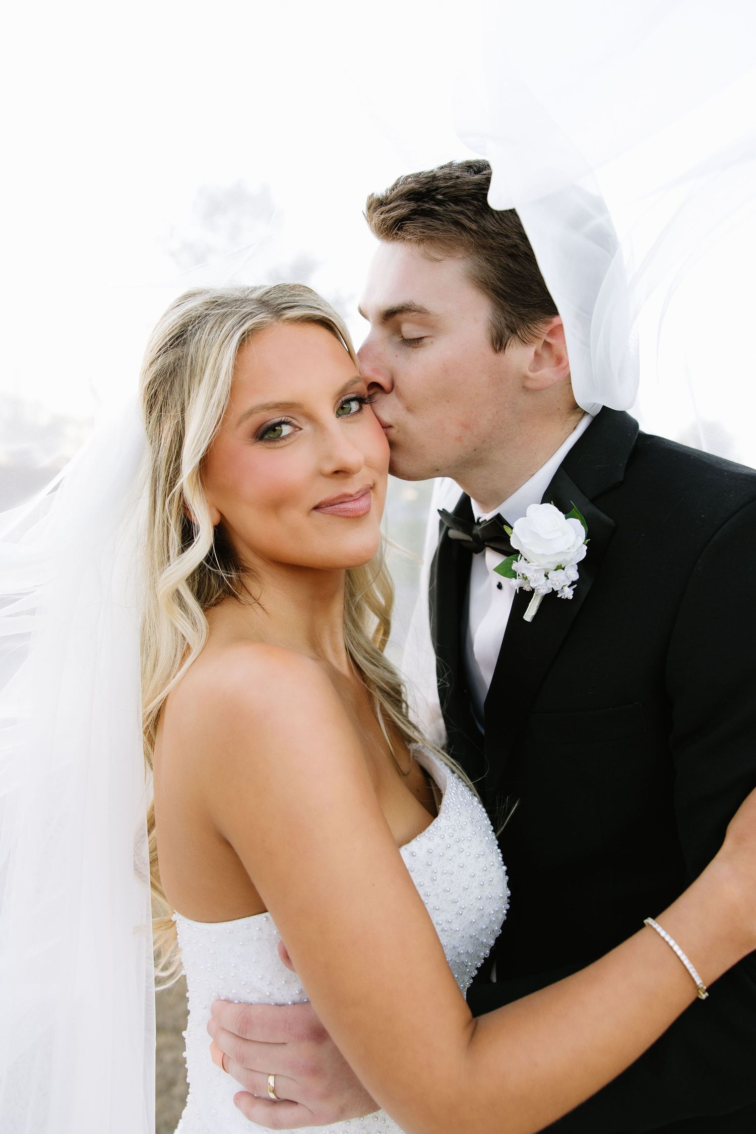 Intimate close-up portrait of newlyweds sharing tender moment.