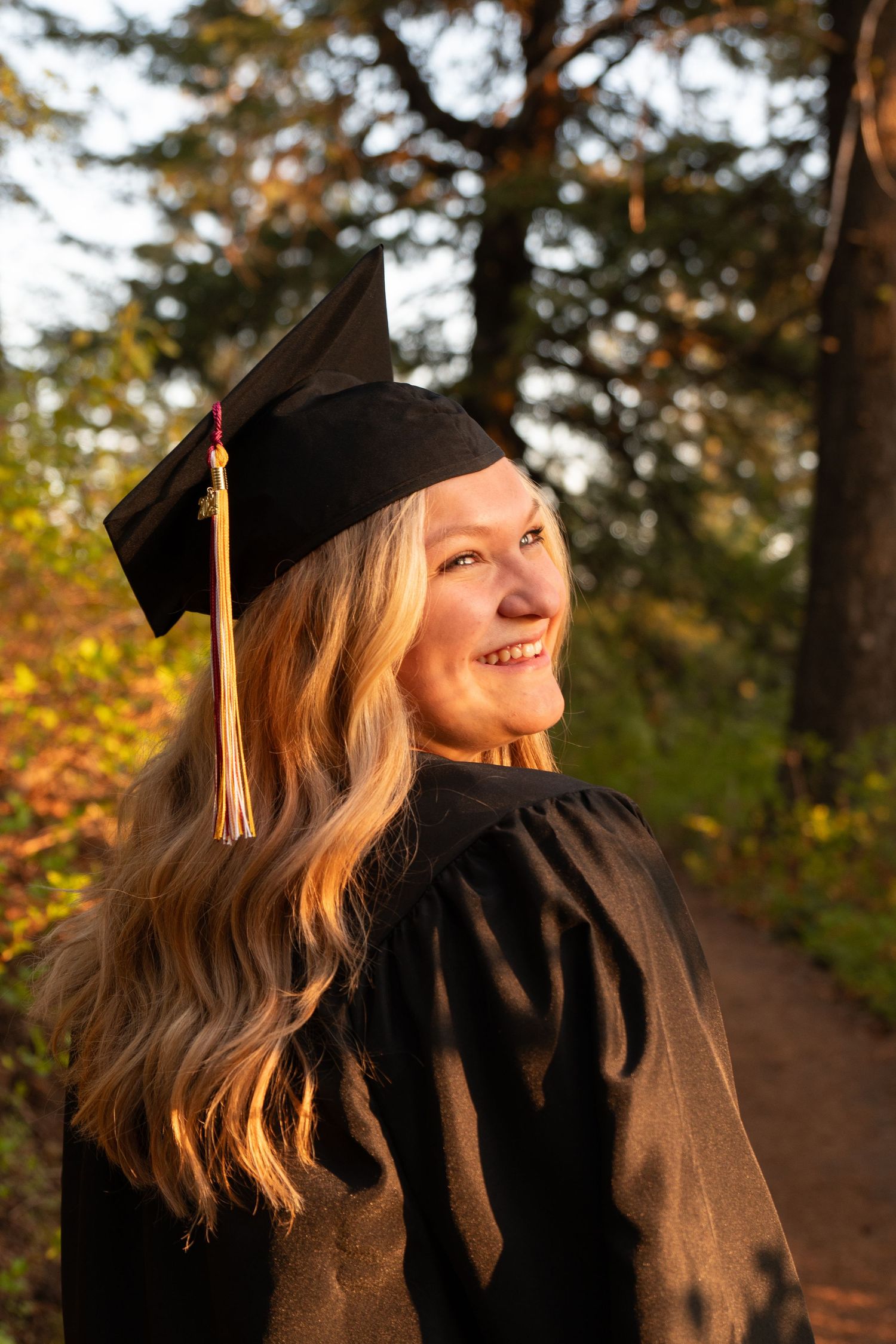 A senior posing in cap and gown in boise, idaho
