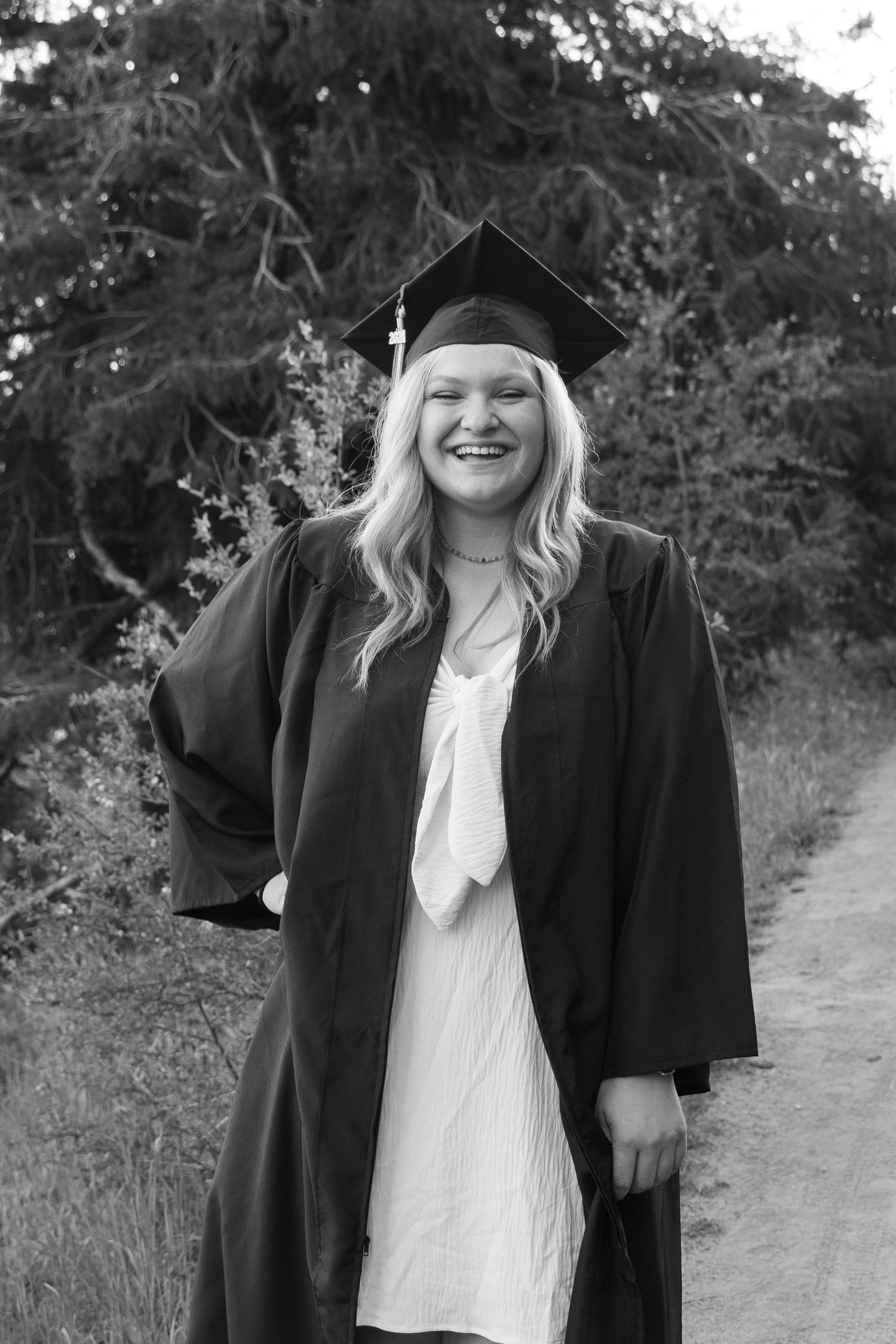 a senior posing in cap and gown in boise, idaho