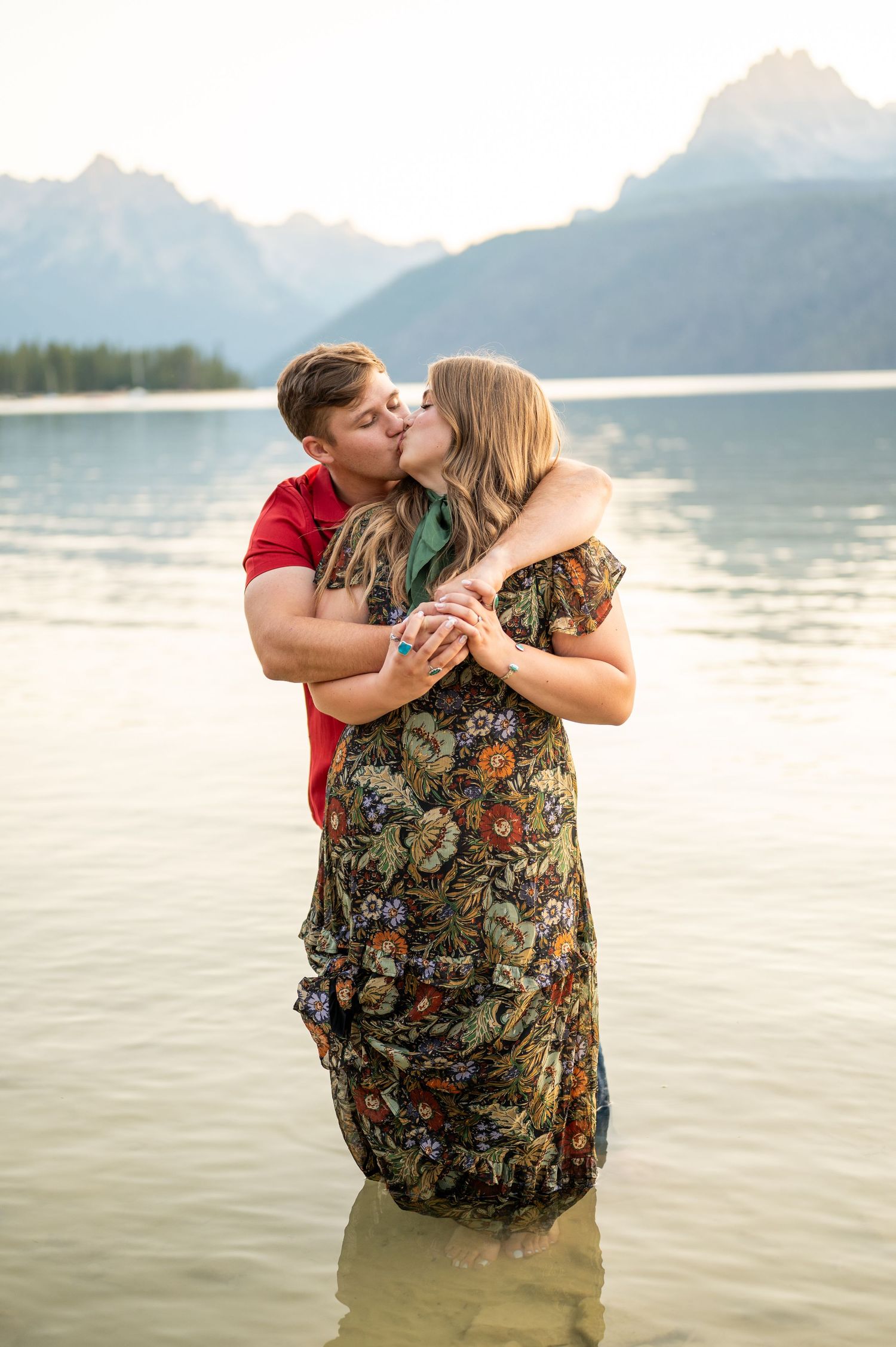 A couple in the water at redfish lake sharing a kiss in Stanley, Idaho.