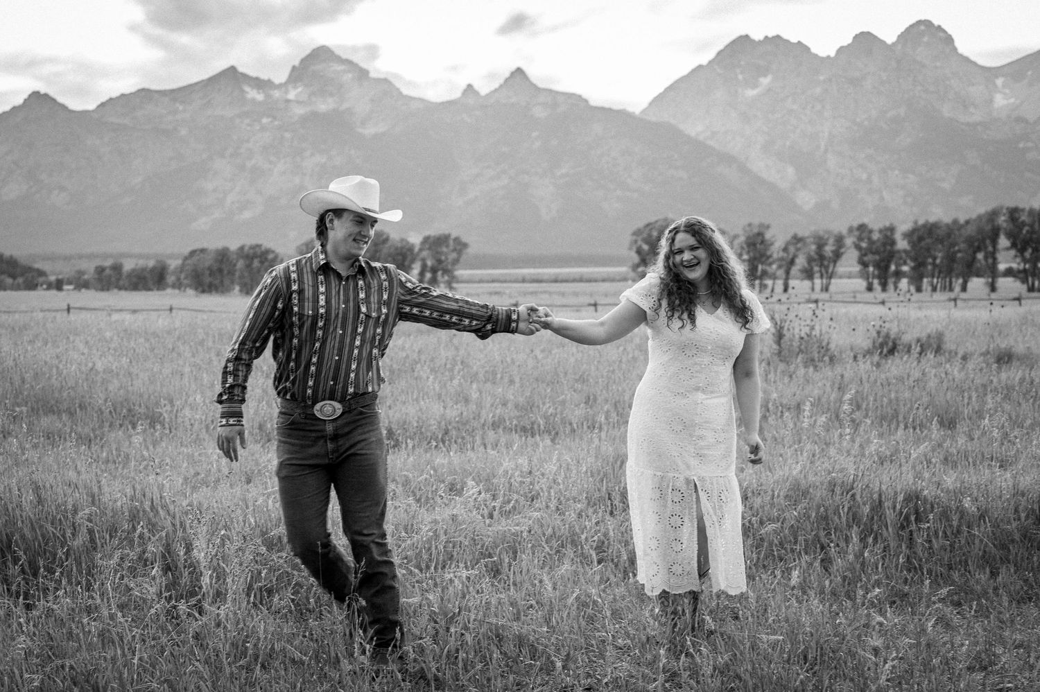 A couple walking together at Mormon Row in Grand Teton National Park.