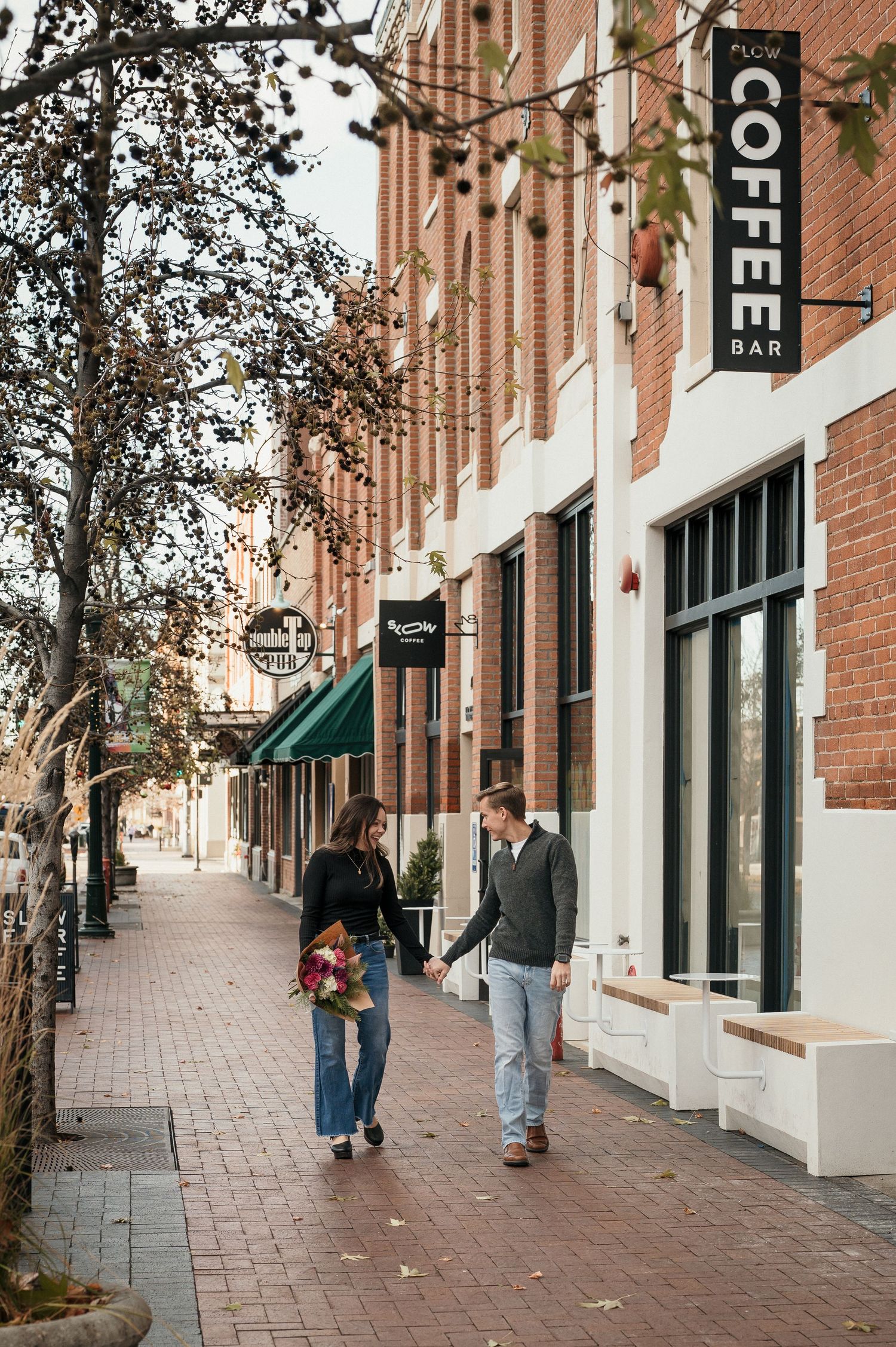 a couple walking the streets of downtown boise, idaho.