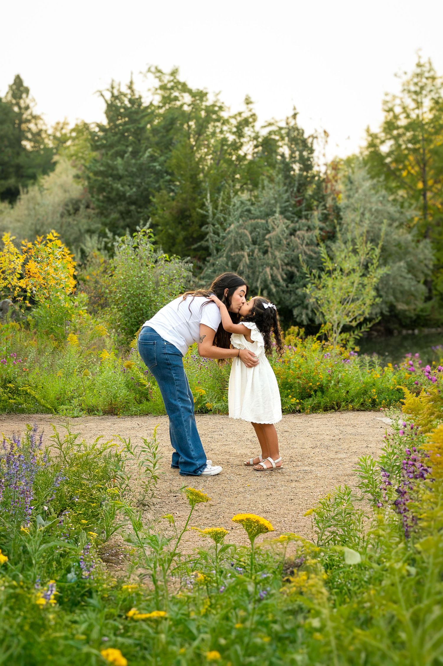 a young daughter giving her mom a kiss in Boise, Idaho.