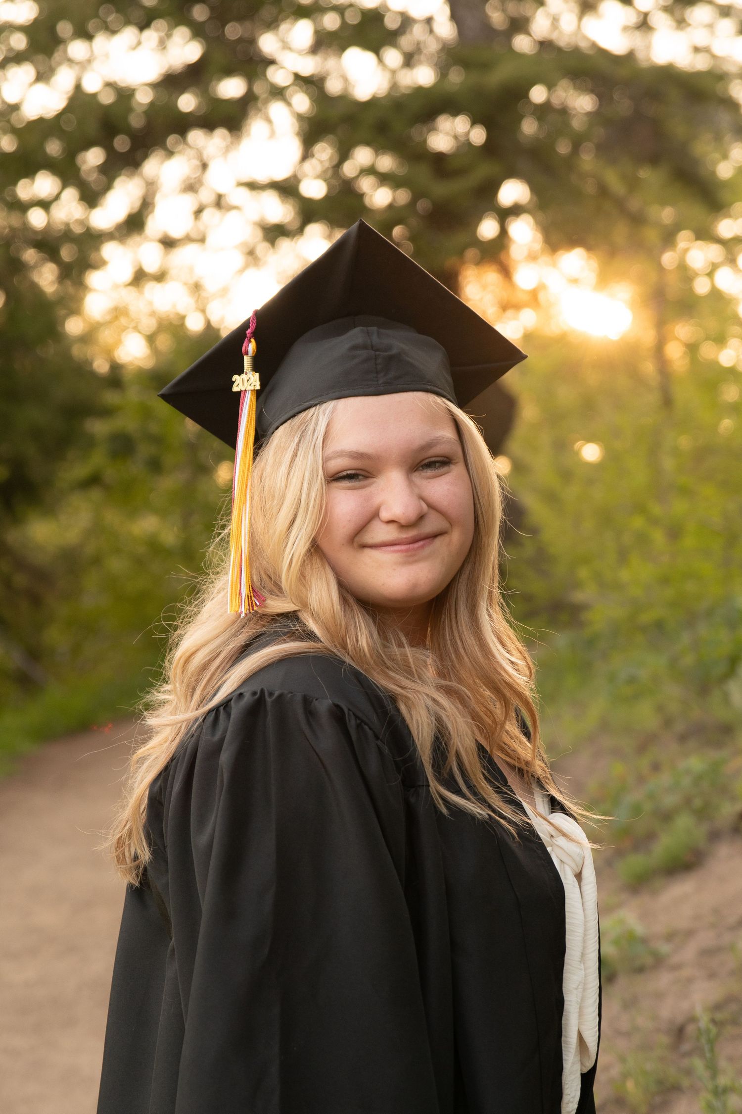 a senior posing in cap and gown in boise, idaho