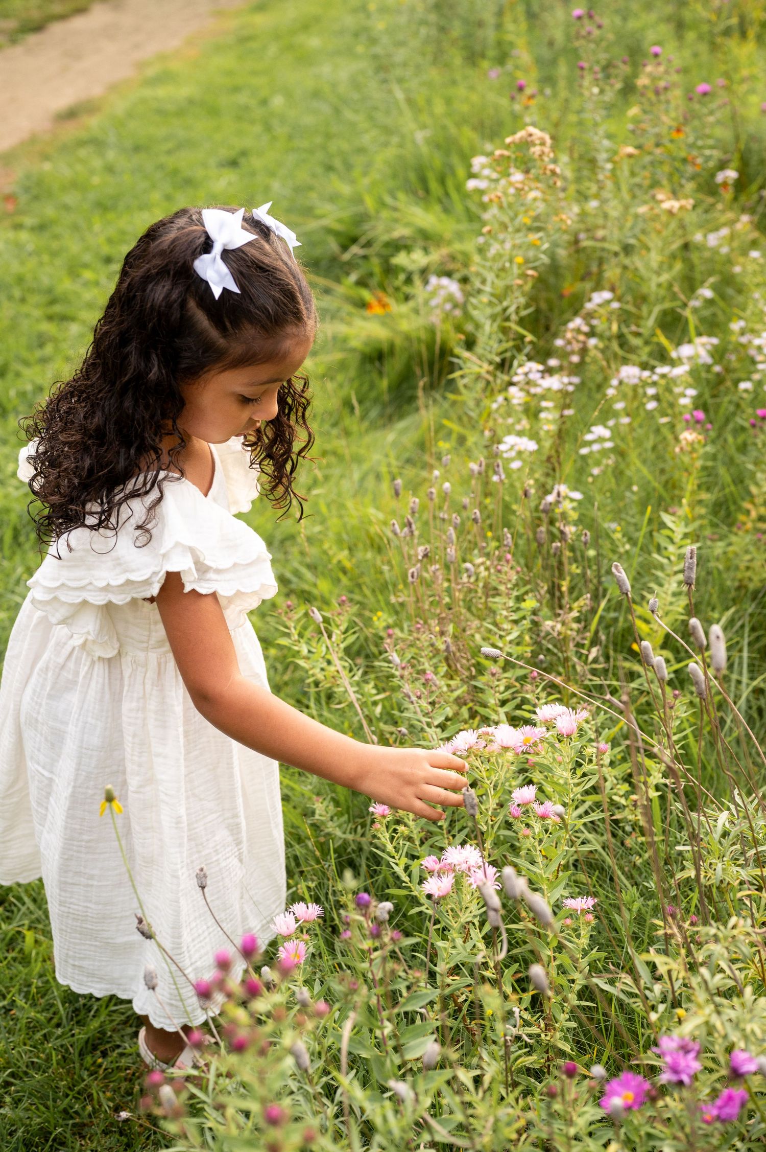 a young girl picking wildflowers in Boise, Idaho