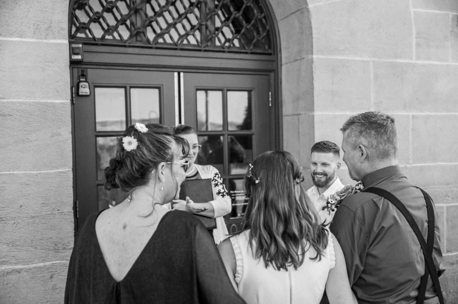 A mother and father pass off their daughter, the bride, to her new husband in Boise, Idaho.