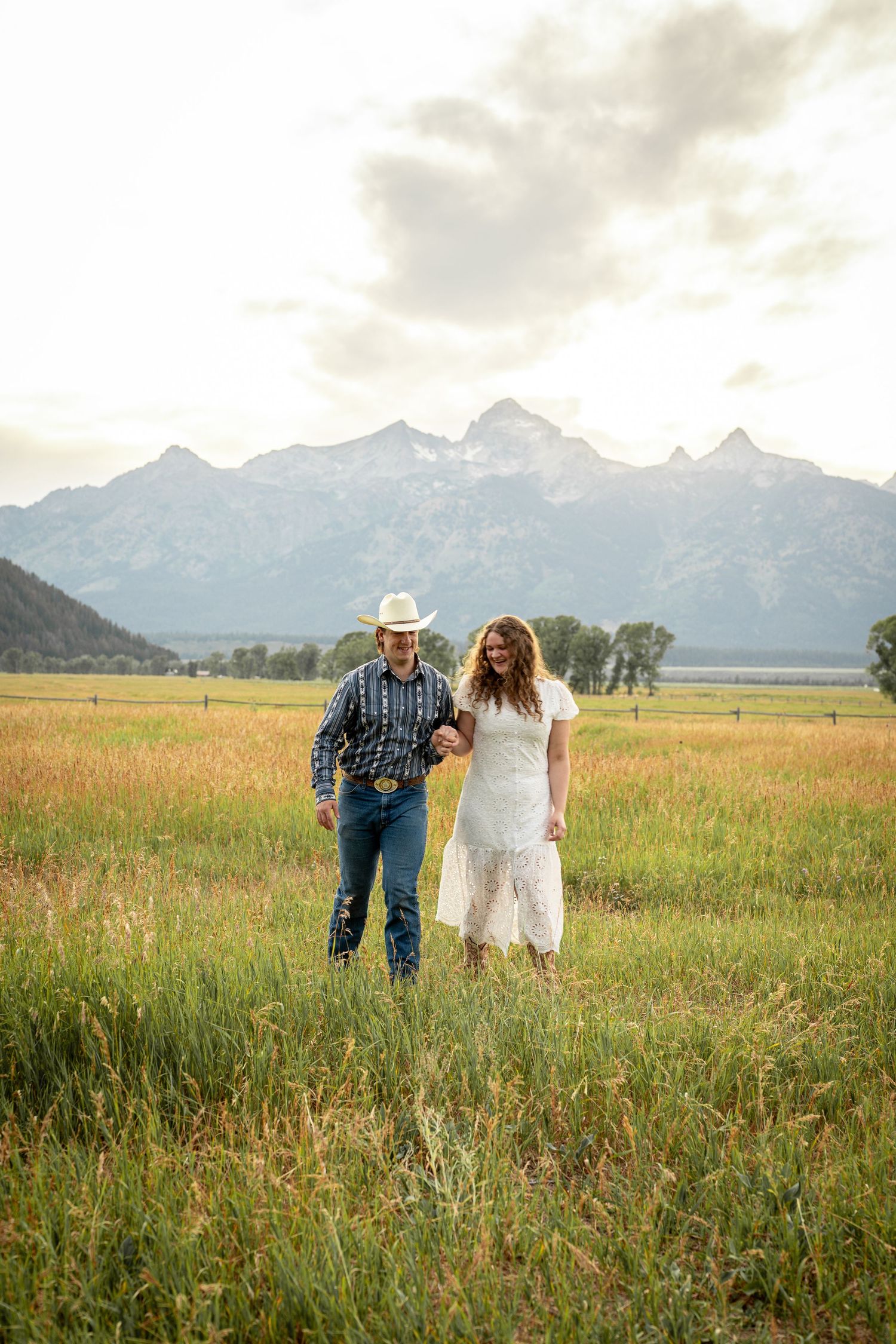 A couple walking together at Mormon Row in Grand Teton National Park.