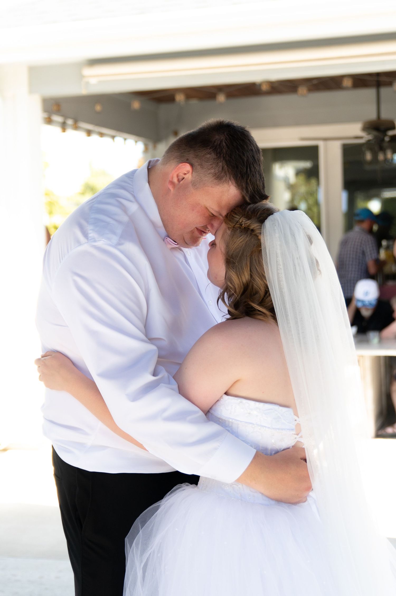 A bride and groom share their first dance at their backyard reception in Meridian, Idaho.
