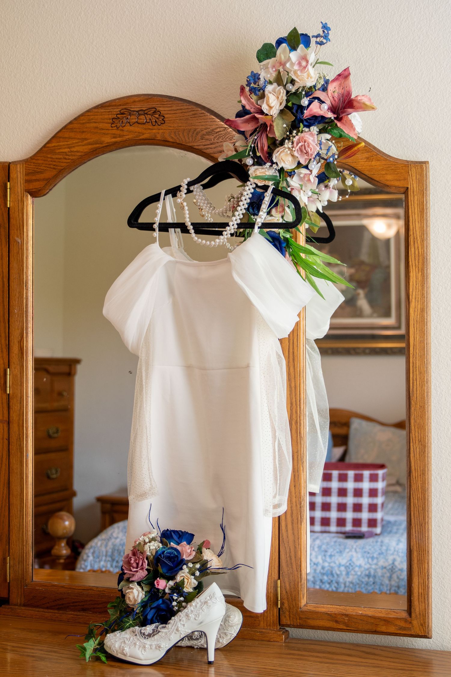 Detail photo of a wedding dress hanging in a brides bedroom before her wedding in Nampa, Idaho.