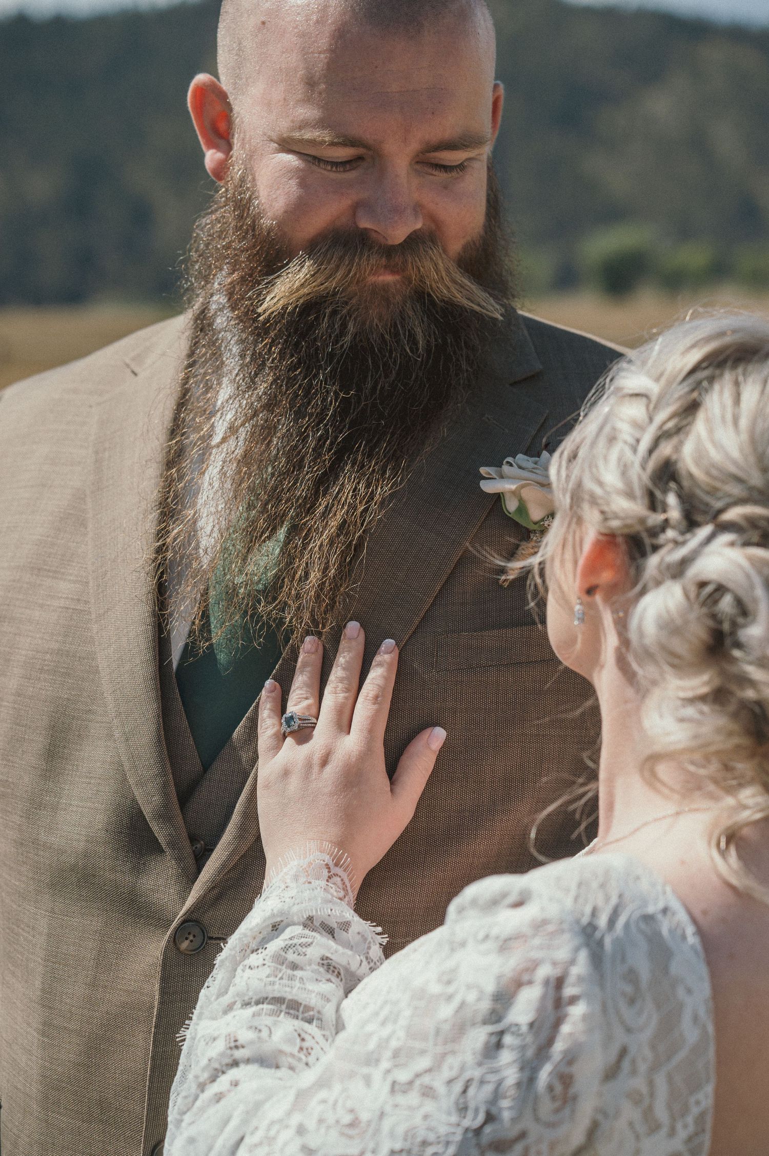 A groom looking down at his bride after their adventurous elopement in Grand Teton National Park.