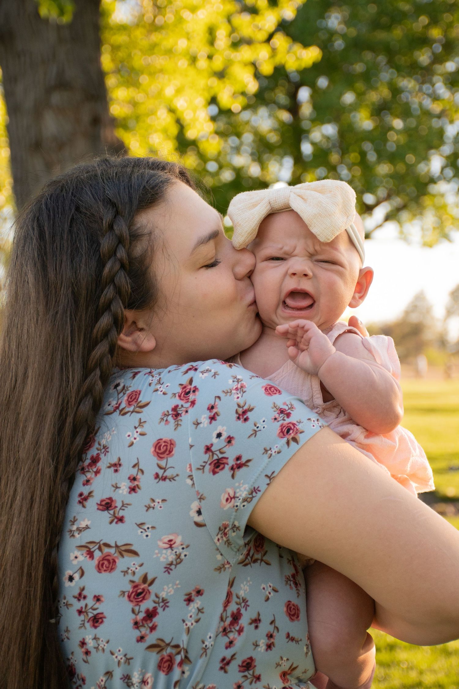 a mom kissing her baby daughter in Nampa, Idaho.