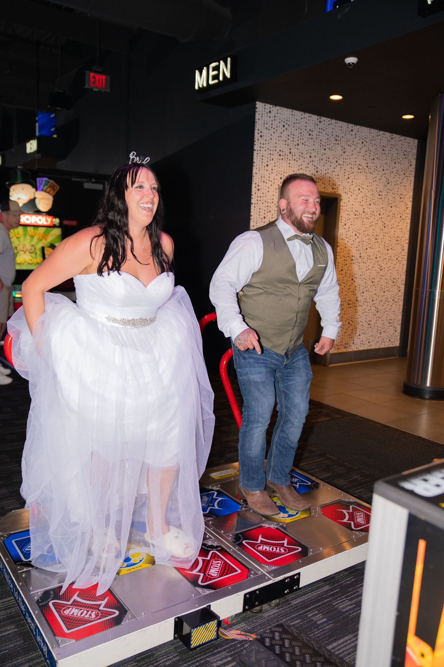 Bride and Groom playing an arcade game they played on their first date in Dave and Busters (Boise, Idaho).