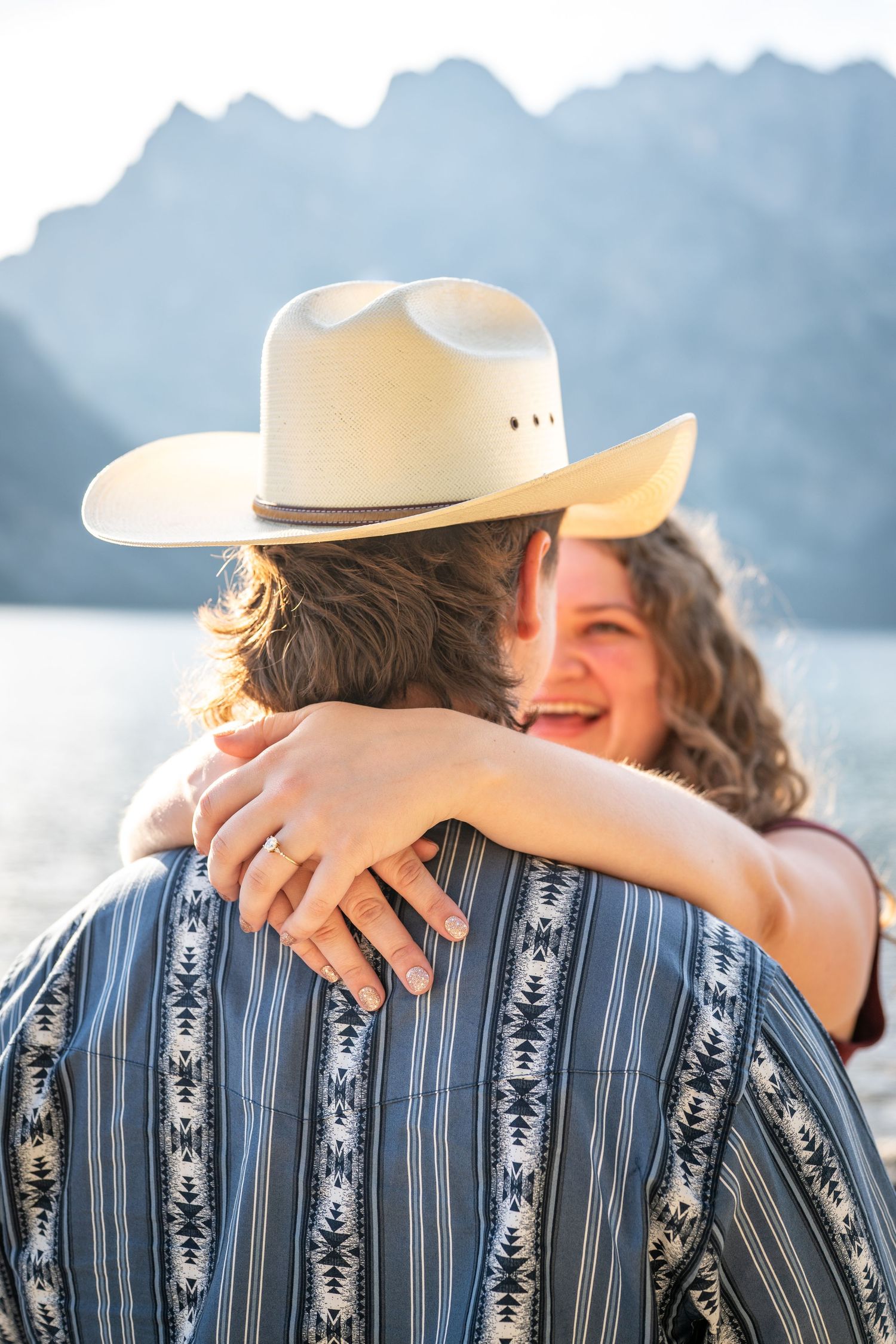 A detail shot of a couple in front of Jenny Lake at Grand Teton National Park.