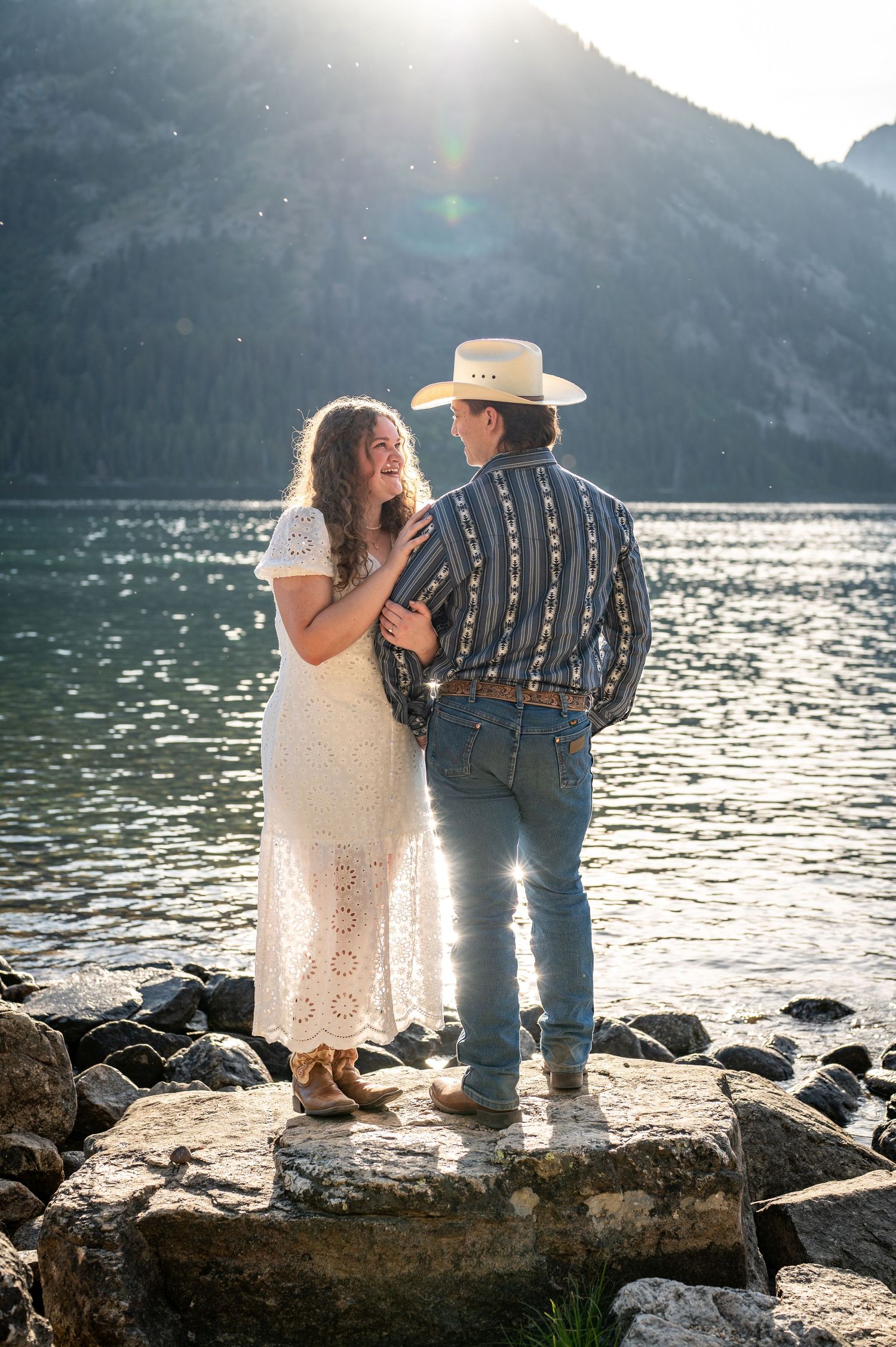 An engaged couple looking at each other during their photoshoot at Jenny Lake in Grand Teton National Park.