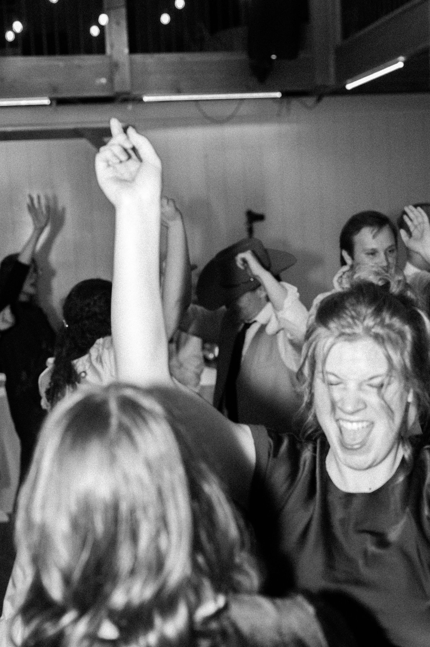 A fun black and white photo of party goers at a wedding reception in Kuna, Idaho