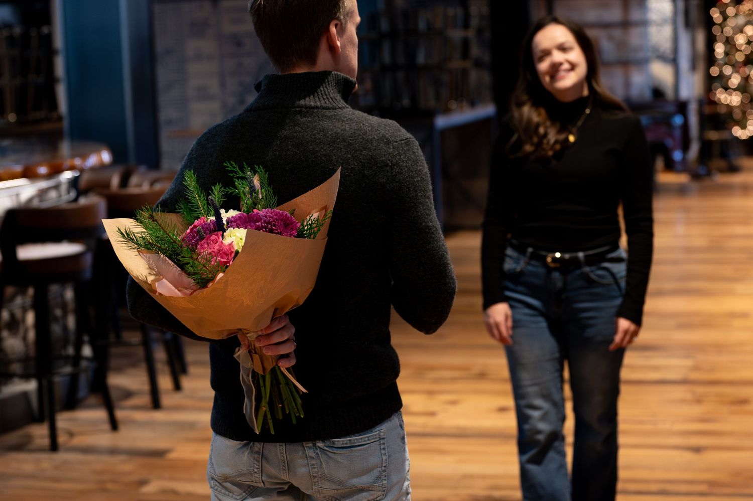 A man surprising his wife with flowers at their shoot in downtown Boise, Idaho.