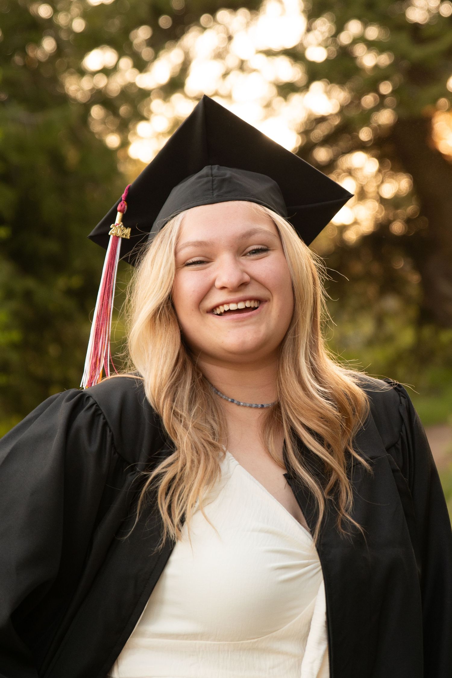 a senior posing in cap and gown in boise, idaho