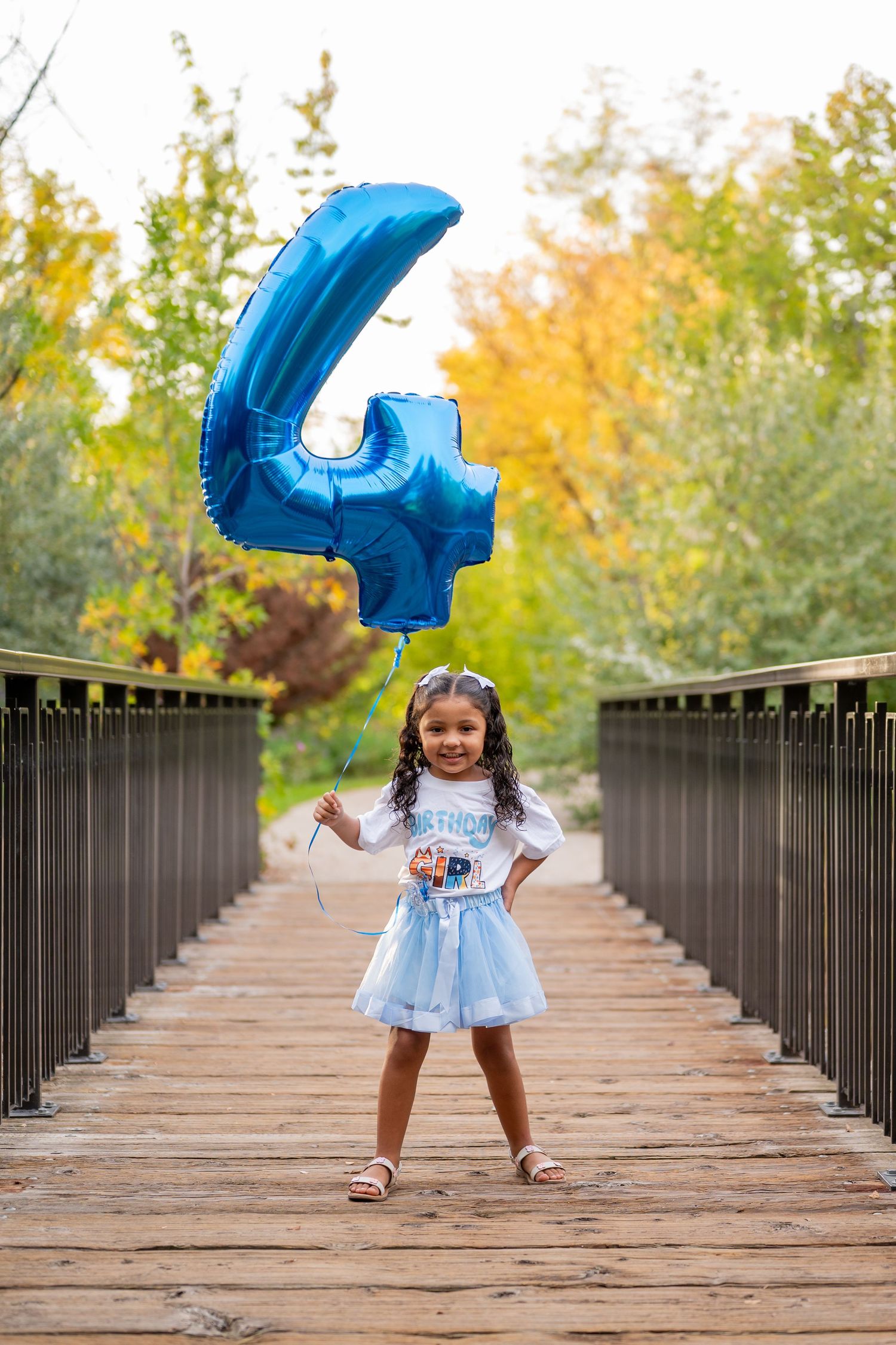a 4 year old girl at her milestone birthday shoot with balloons! Boise, Idaho.