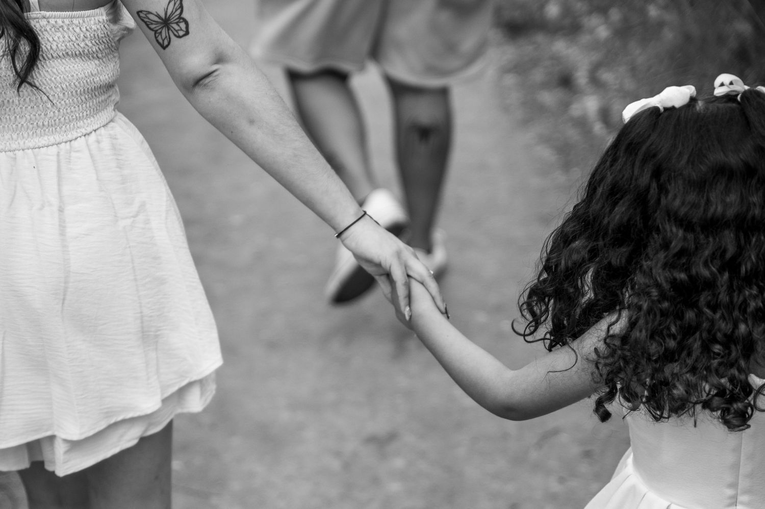 a mom and daughter holding hands in boise, idaho.