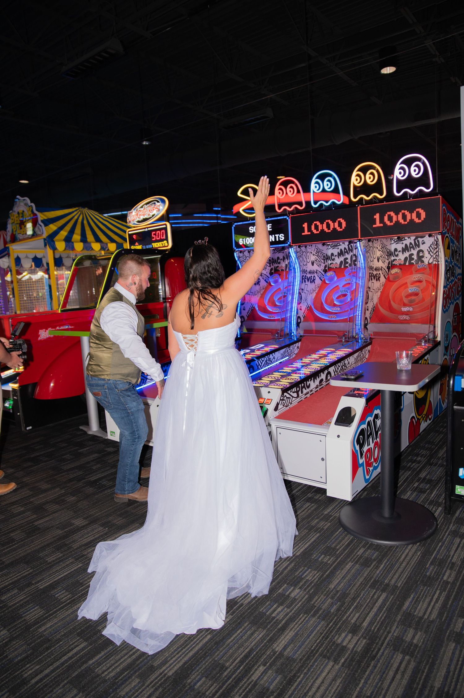 A bride and groom playing arcade games after their ceremony at Dave & Busters in Boise, Idaho.