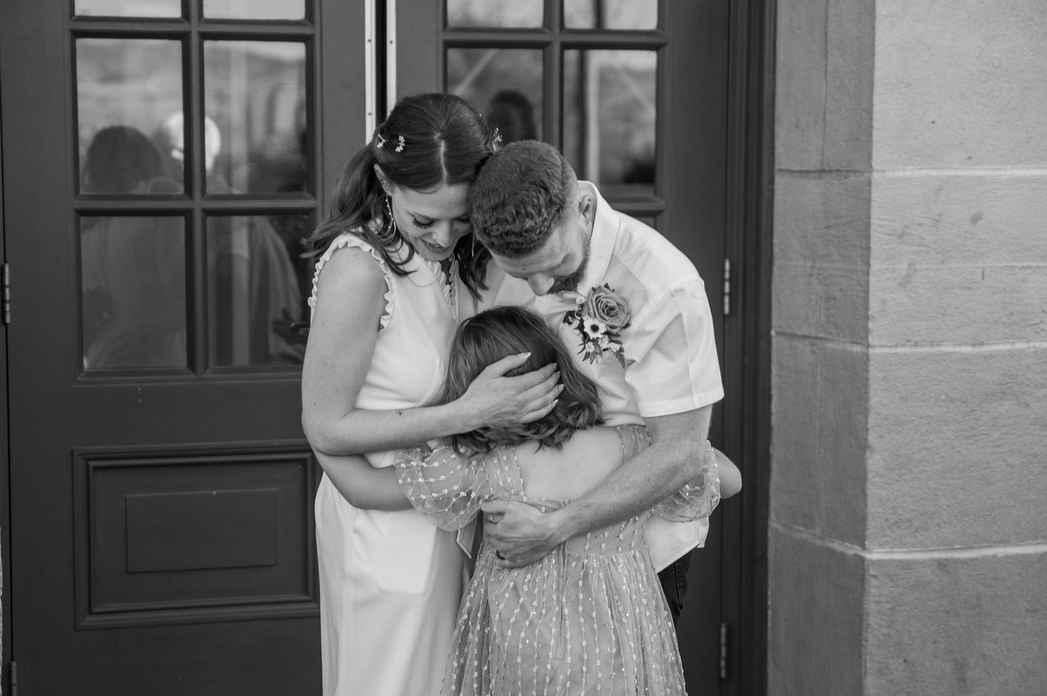 An emotional hug between a young daughter and her freshly married parents in Boise, Idaho.