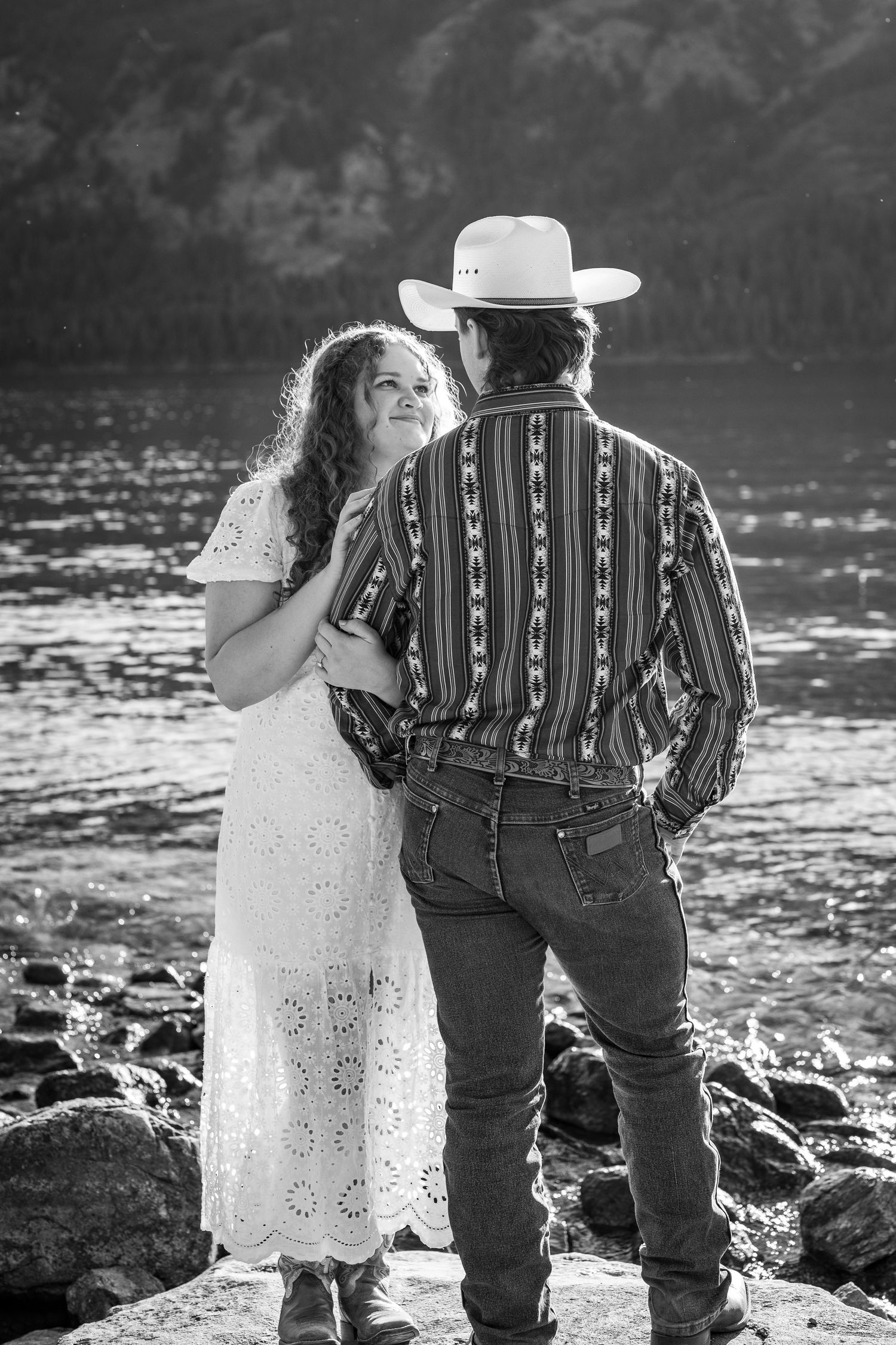 An engaged couple looking at each other during their photoshoot at Jenny Lake in Grand Teton National Park.