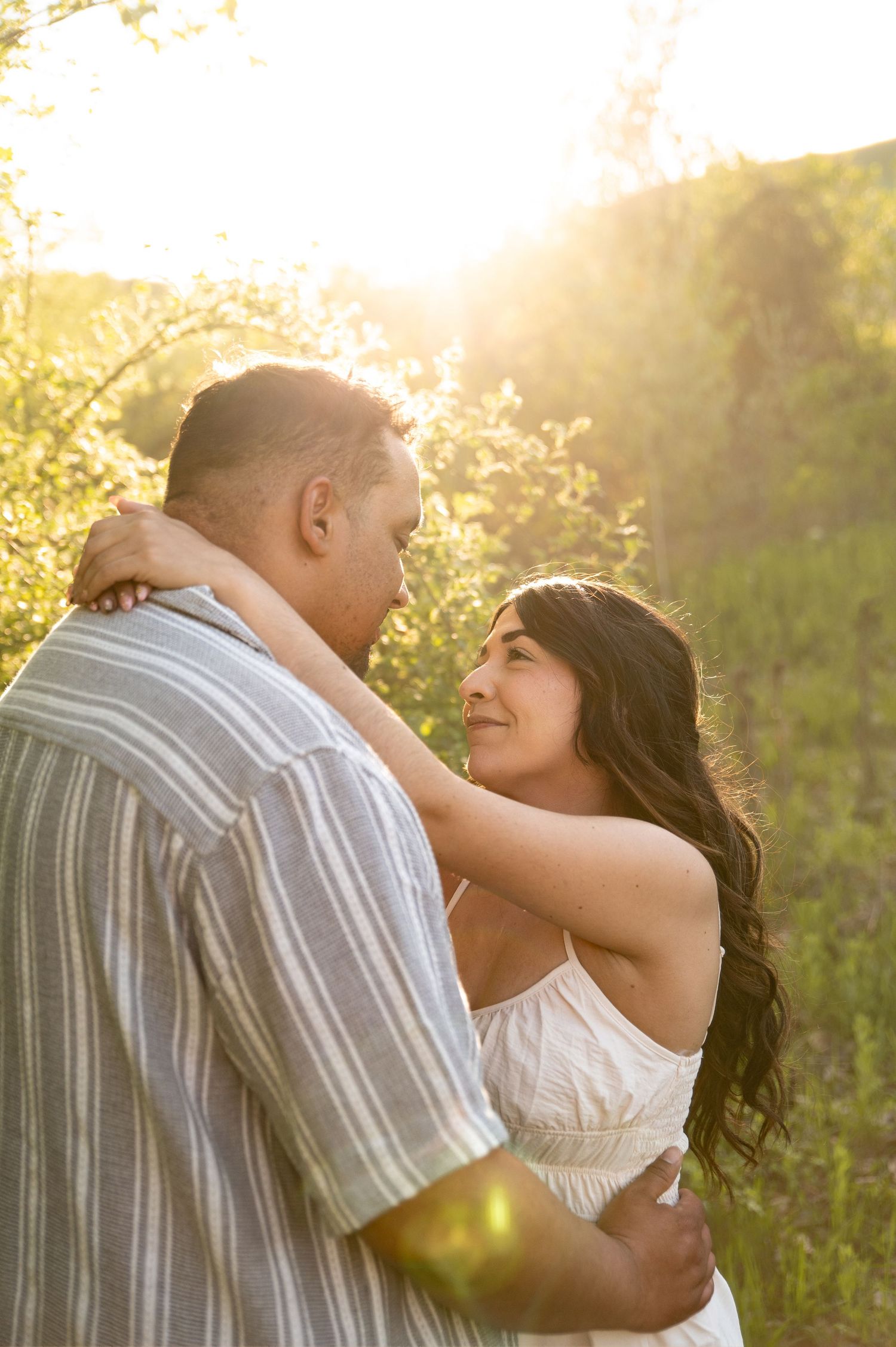 A couple looking at each other during golden hour at Camels back park in Boise, Idaho.