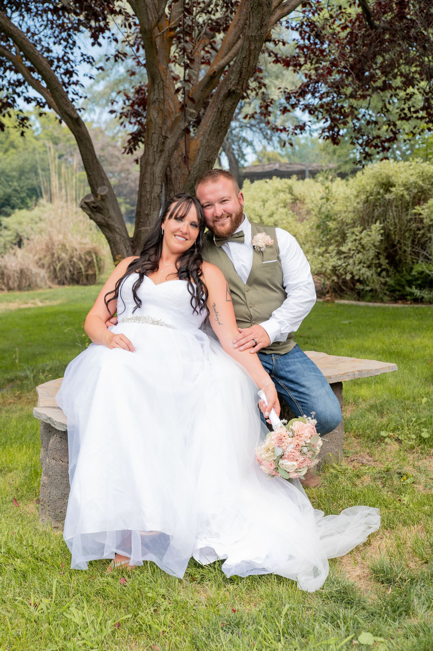 A bride and groom relax together for a casual portrait session after their ceremony in Boise, Idaho.