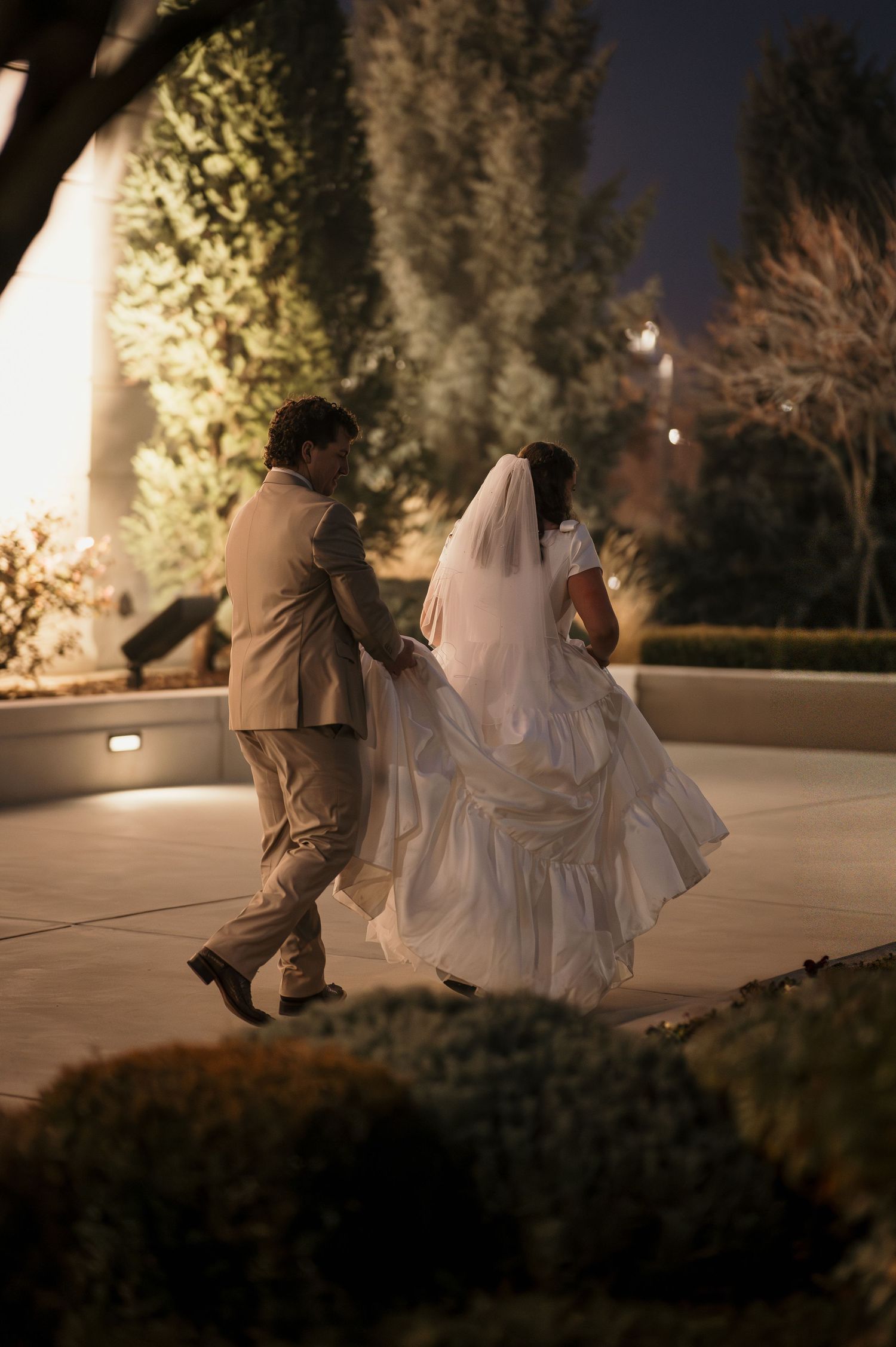 A newly married couple walking outside the LDS Meridian Idaho Temple