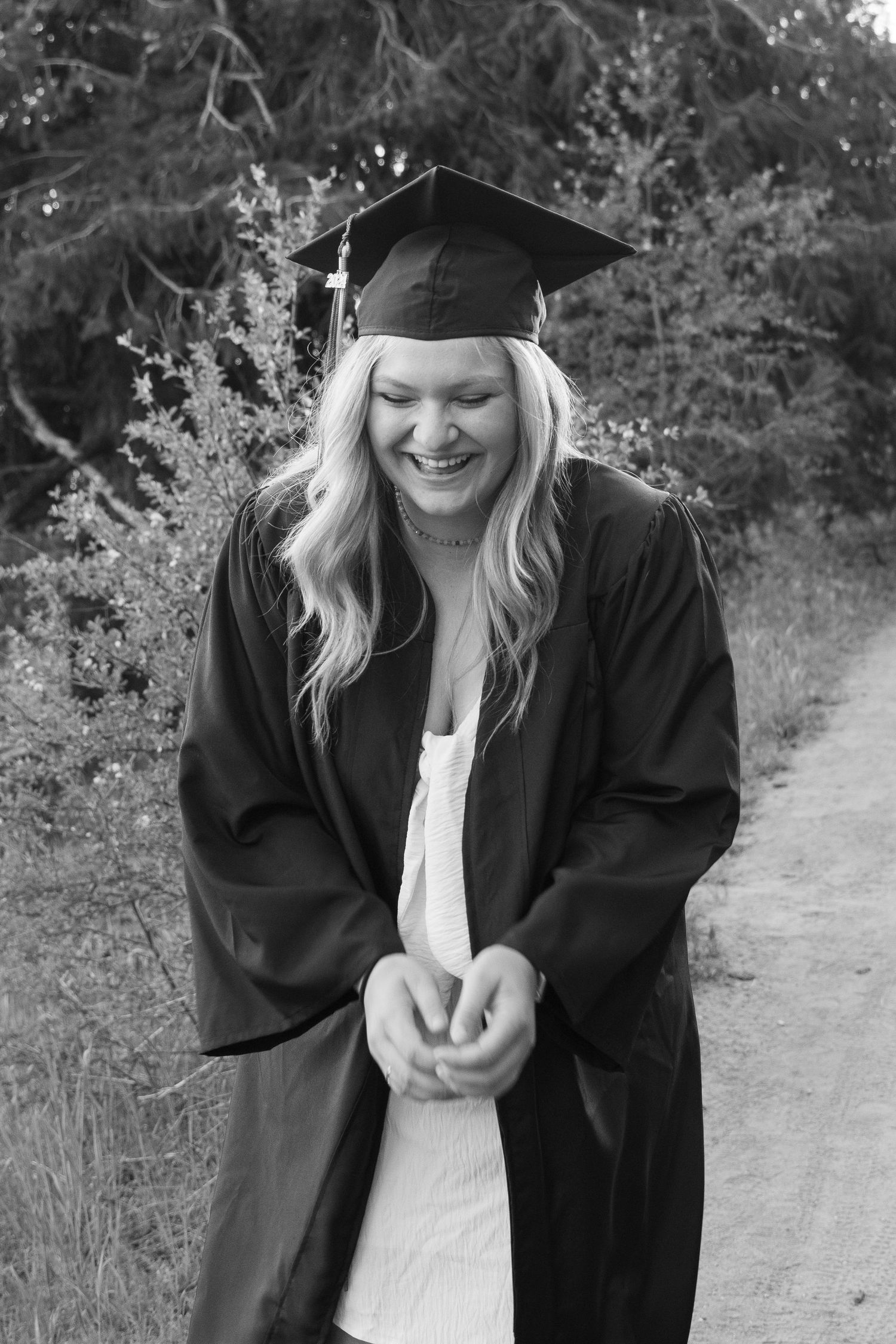 a senior posing in cap and gown in boise, idaho