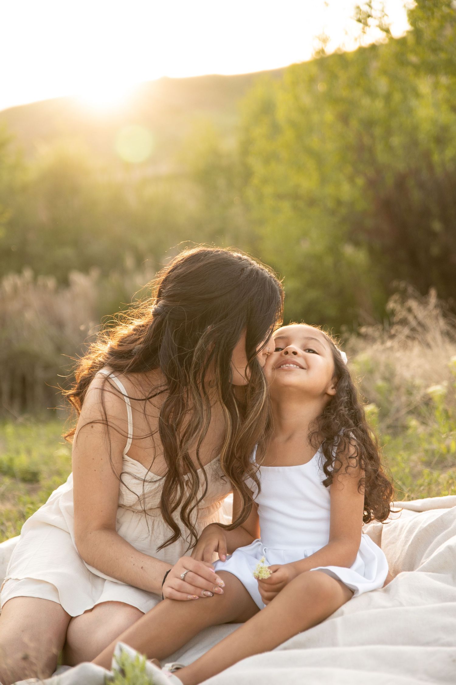 a mom kissing her young daughter on the cheek in boise idaho