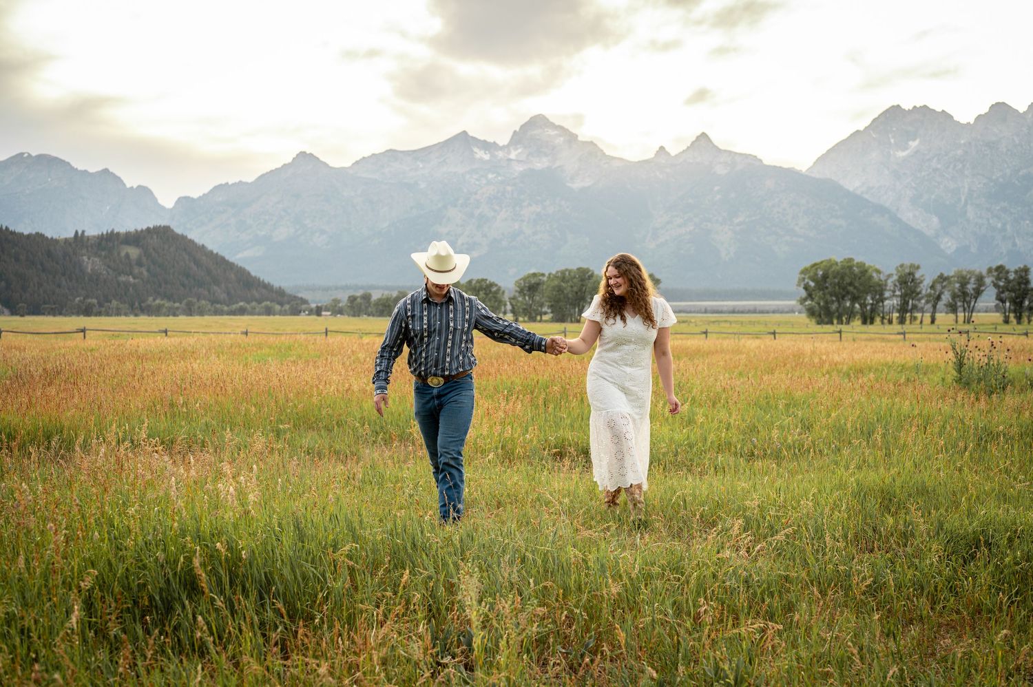 A couple walking together at Mormon Row in Grand Teton National Park.