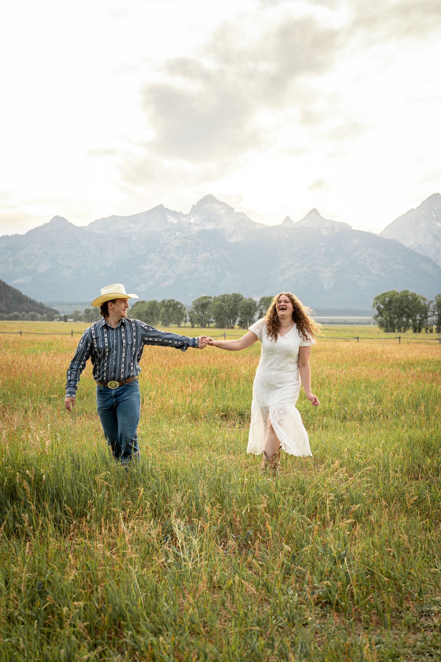 A couple walking together at Mormon Row in Grand Teton National Park.