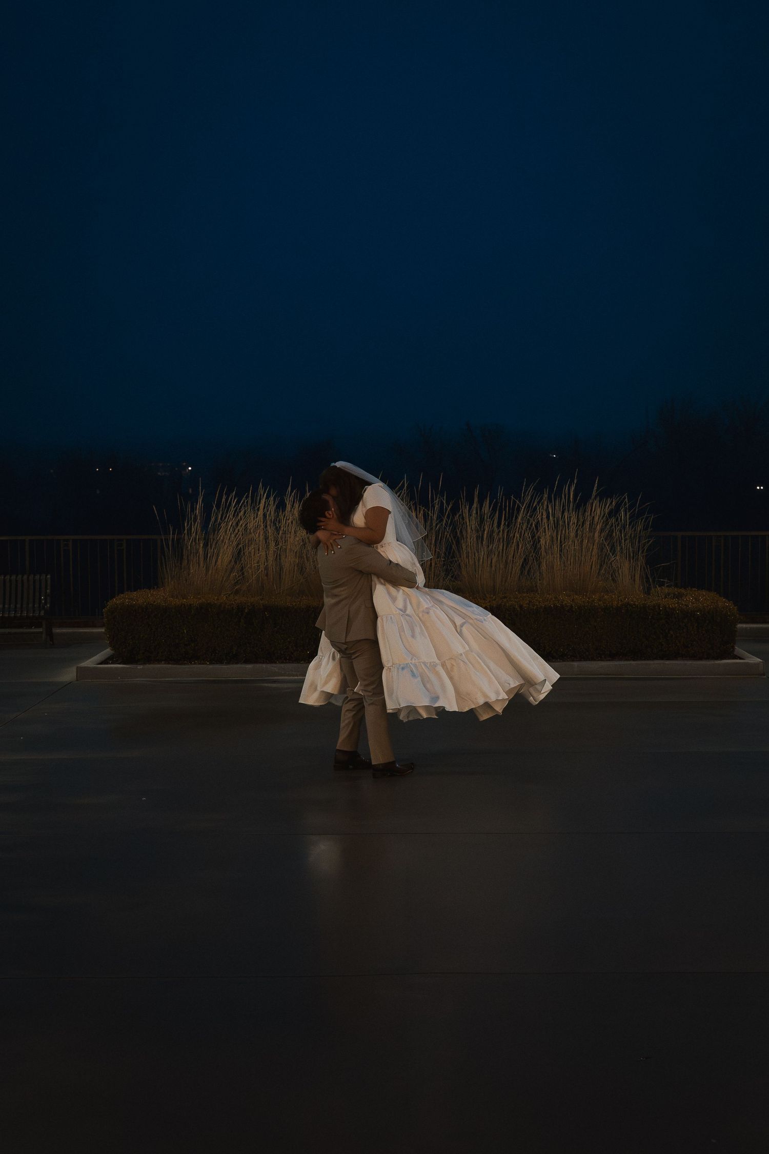 A newly married couple dancing outside the LDS Meridian Idaho Temple at night