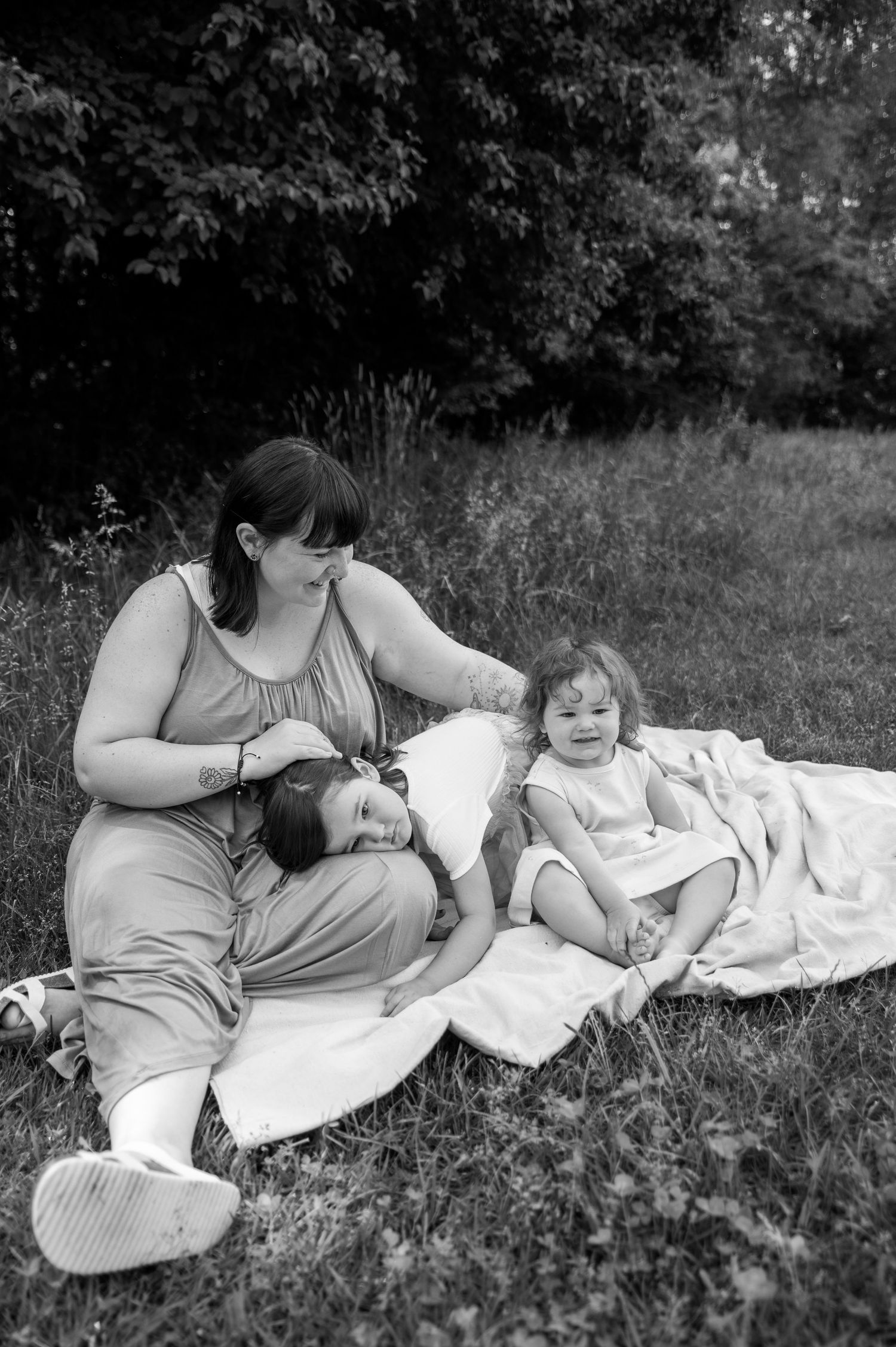 a group photo of a mom with her two young daughters