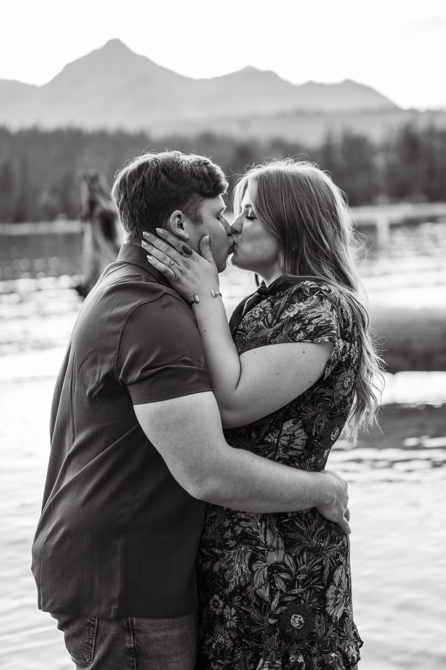 A couple kissing while in the water of Redfish Lake with the Sawtooth Mountains in the background.