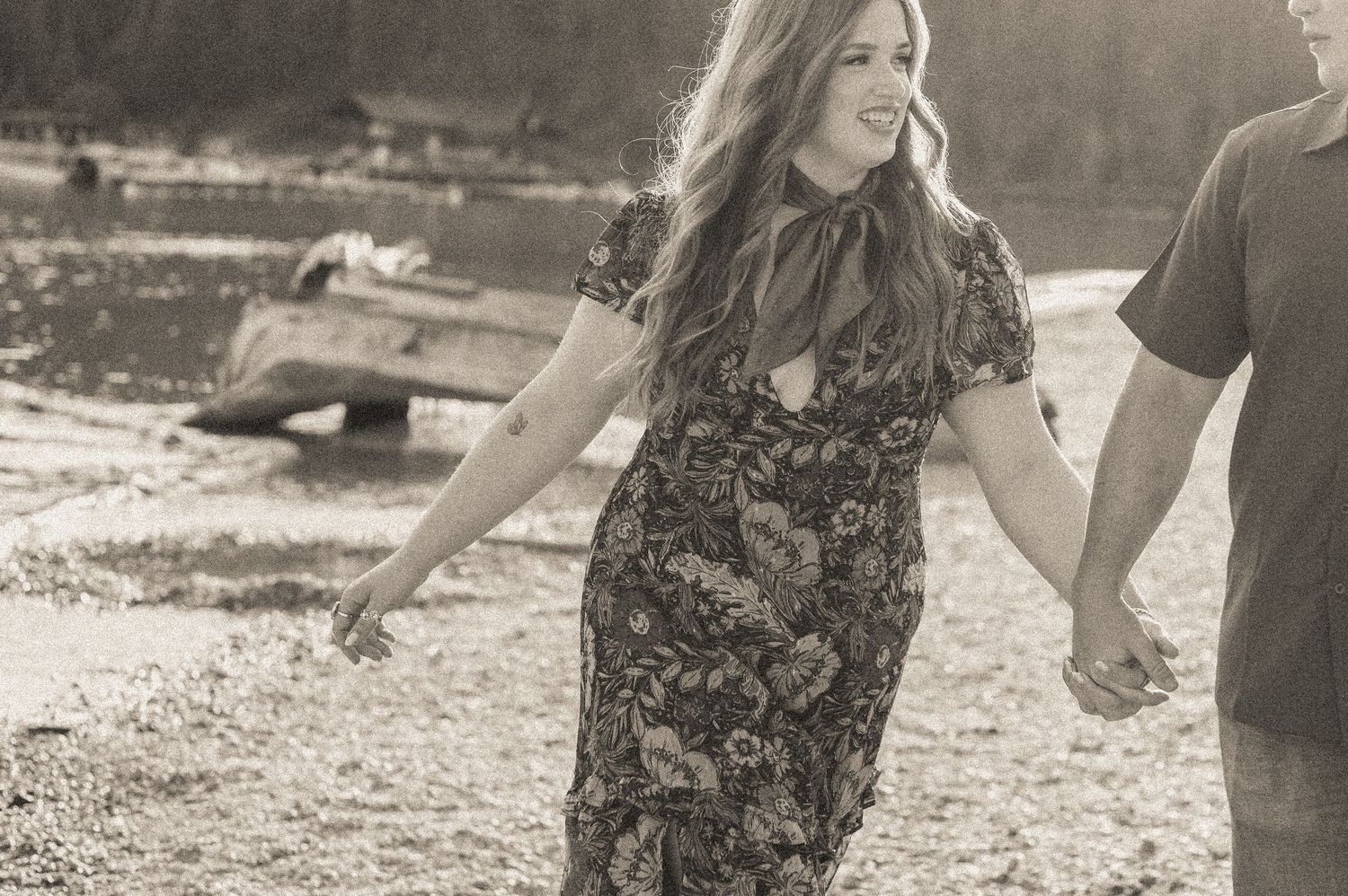 A cinematic detail shot of a couple walking together on the shores of Redfish lake in Stanley, Idaho.