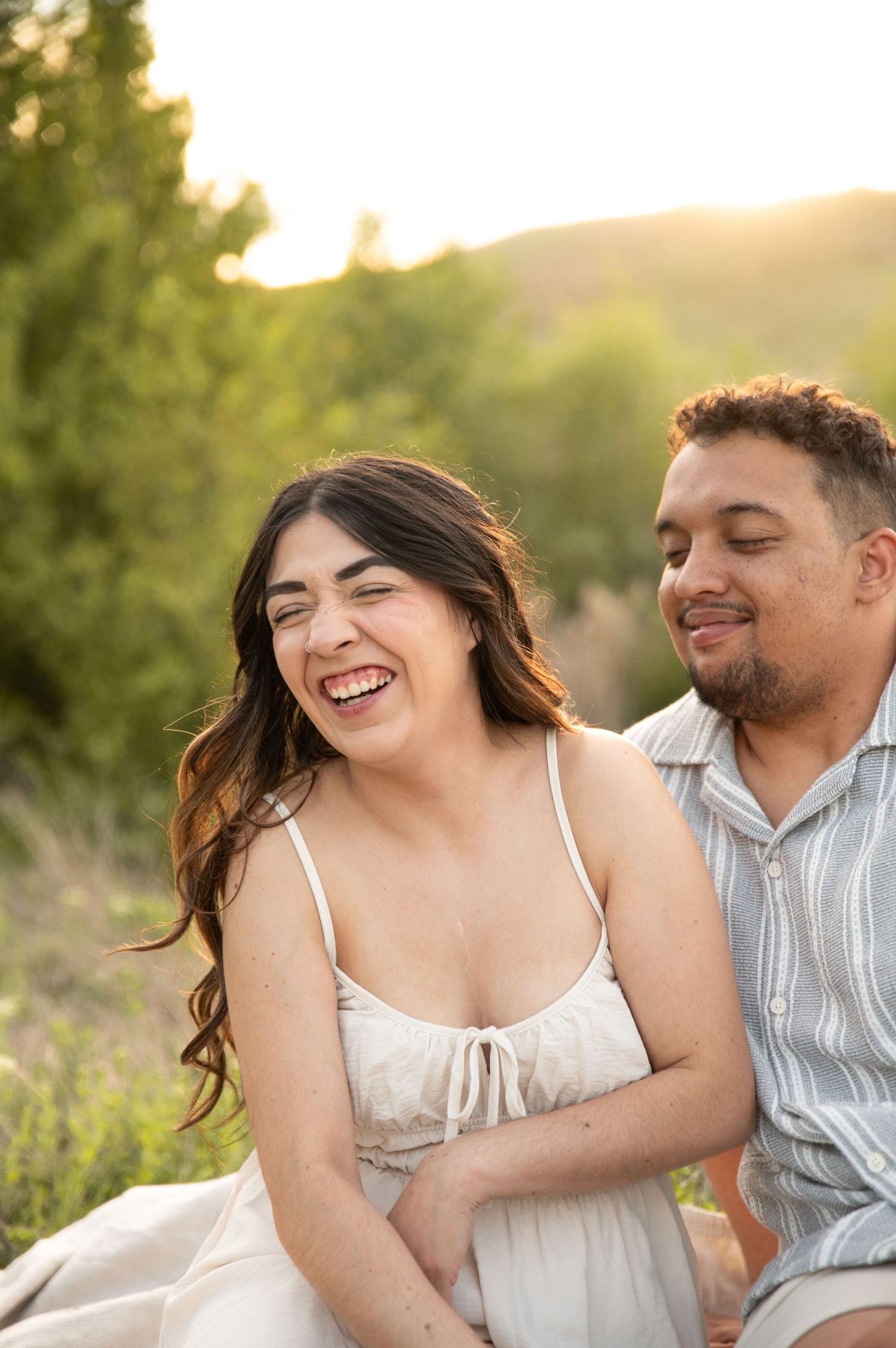 a candid moment of laughter during a couple shoot at golden hour in boise, idaho.