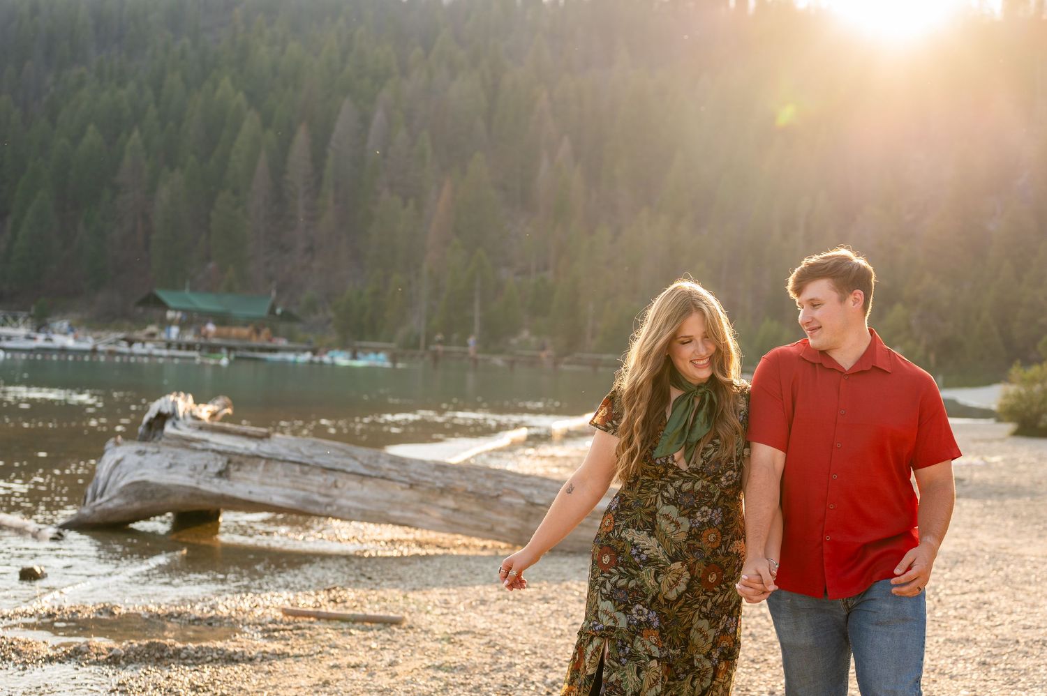A couple walking at Redfish lake in front of the Sawtooth mountains.