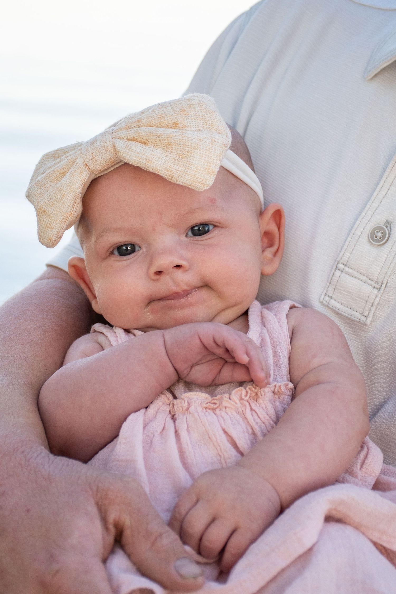 A little baby girl looking at the camera during a family session in Nampa, Idaho.
