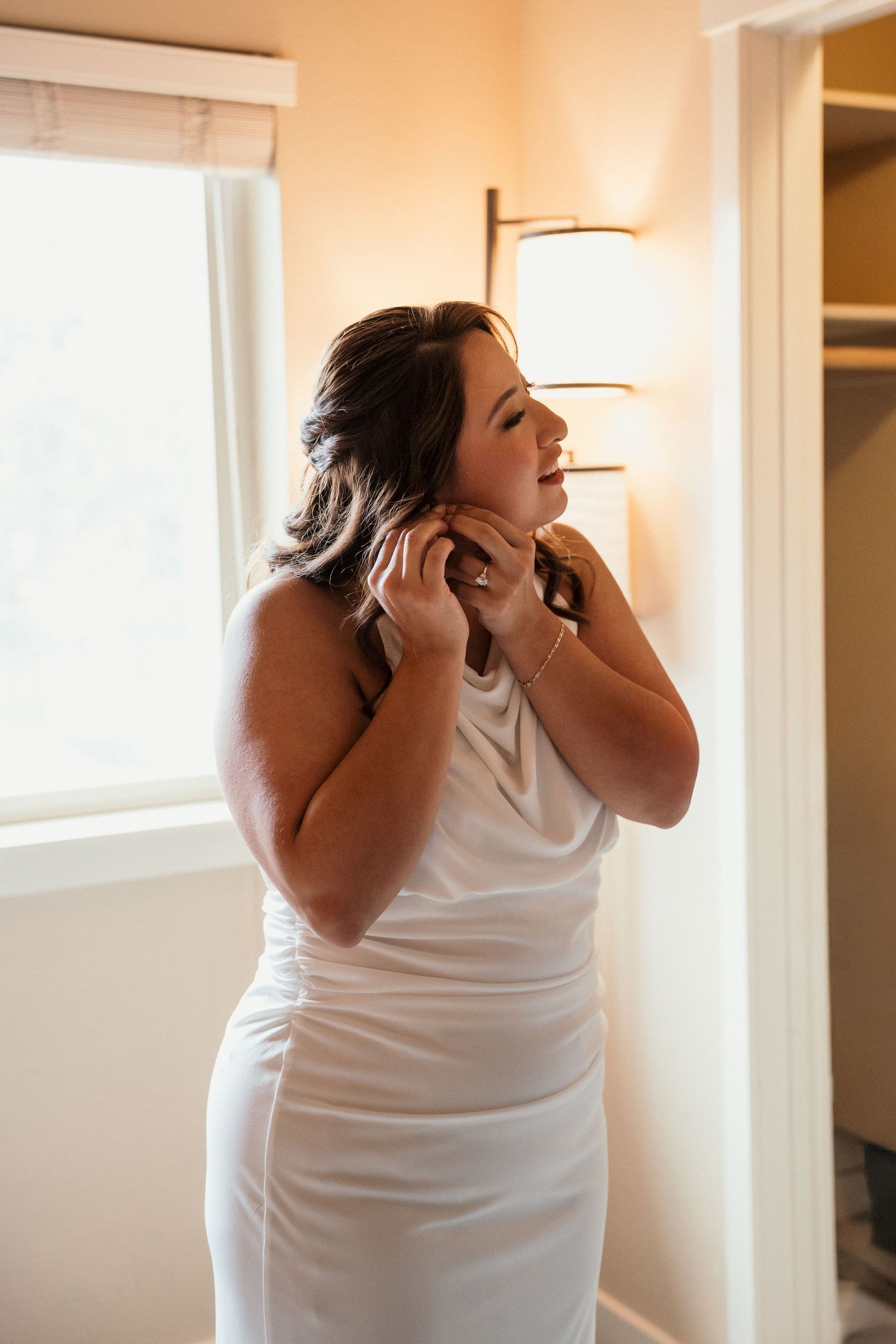 Bride getting ready indoors with soft timeless lighting in Boise, Idaho.