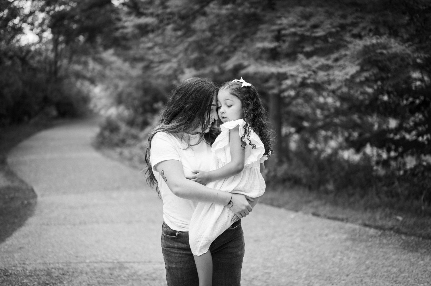 a mom and her daughter snuggled up in a cozy black and white photo in boise idaho