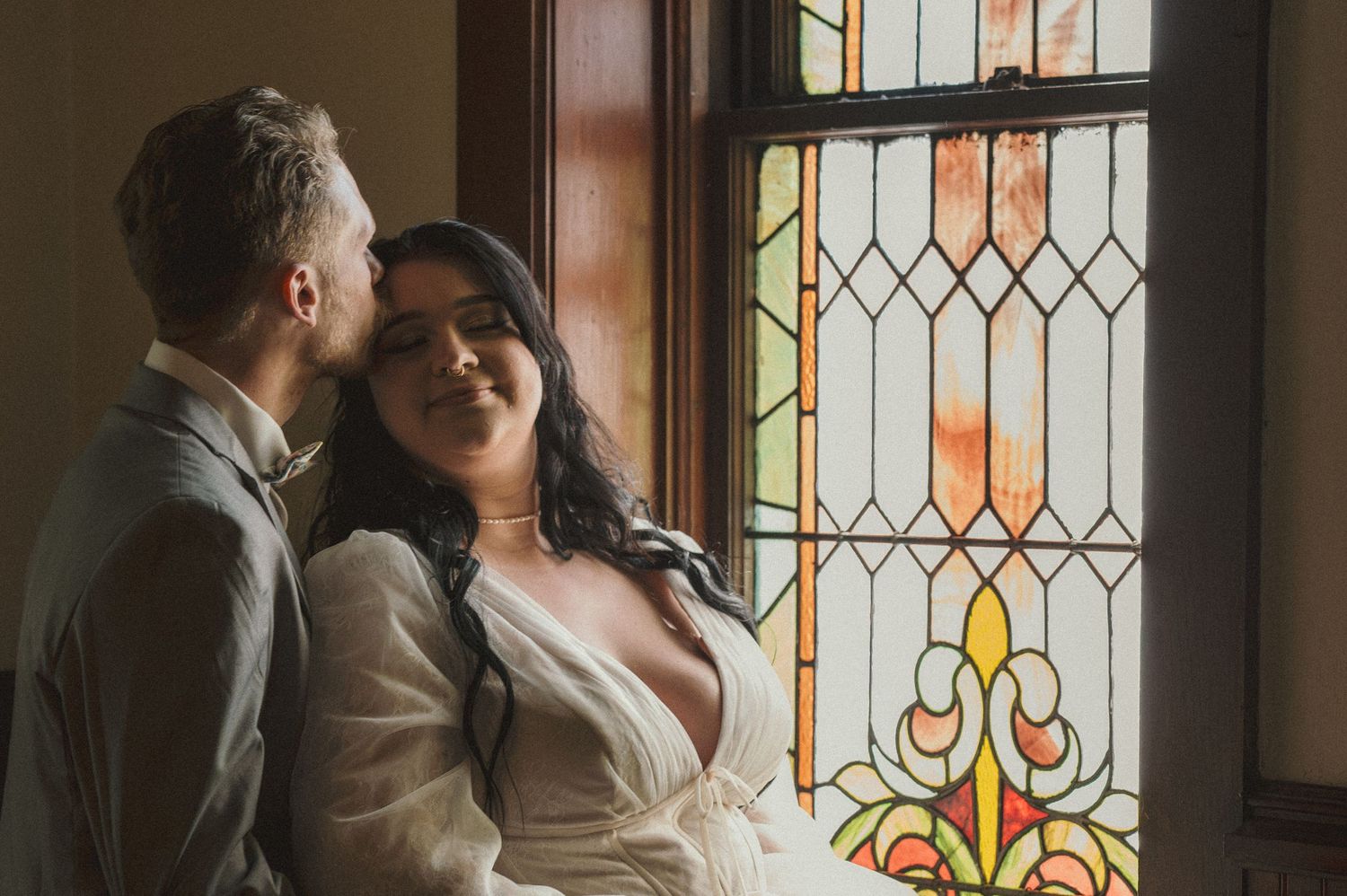 Bride and Groom portrait in front of a stained glass window in Payette, Idaho.