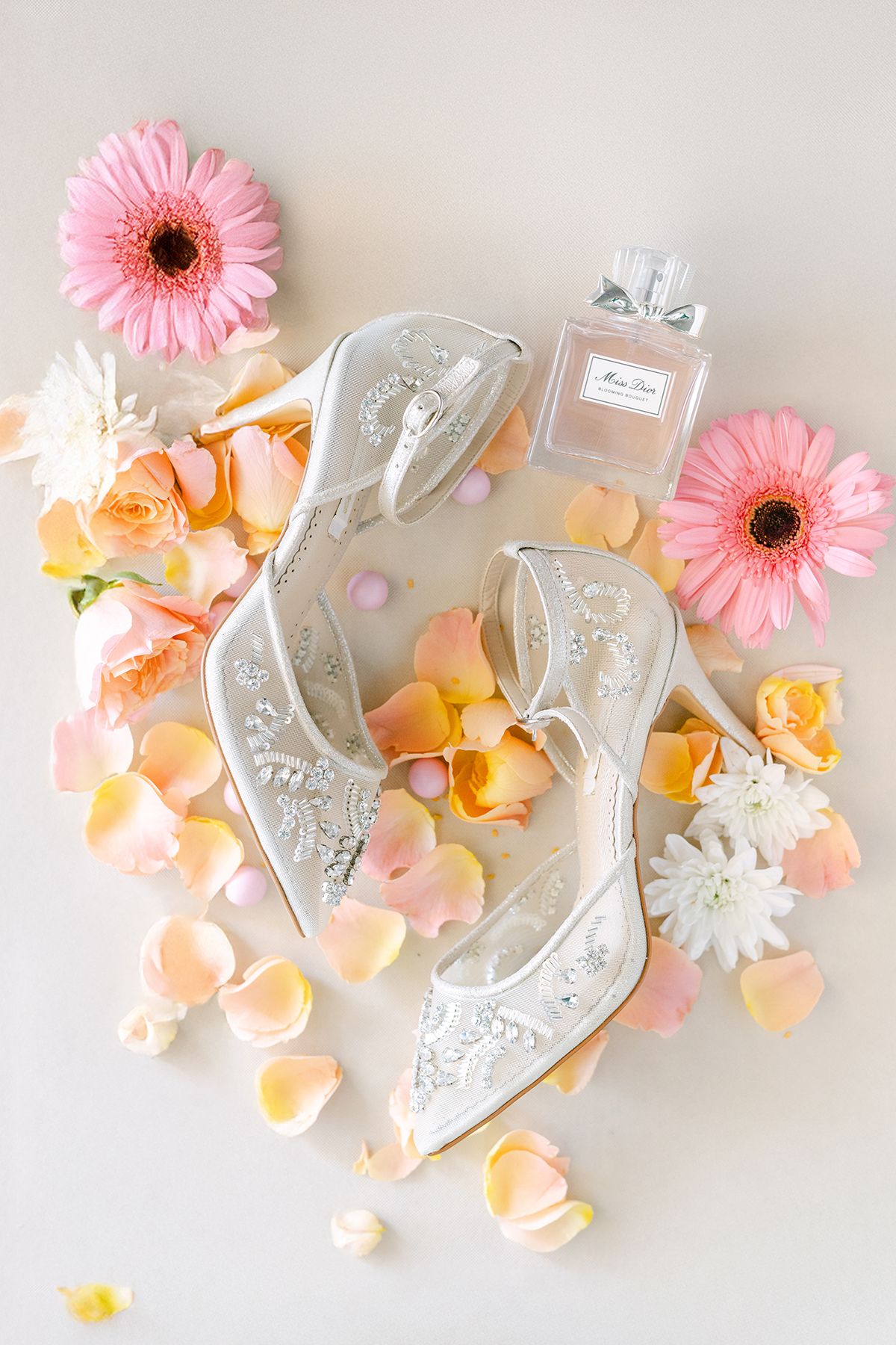 Close-up of wedding shoes on textured fabric, photographed in natural light.