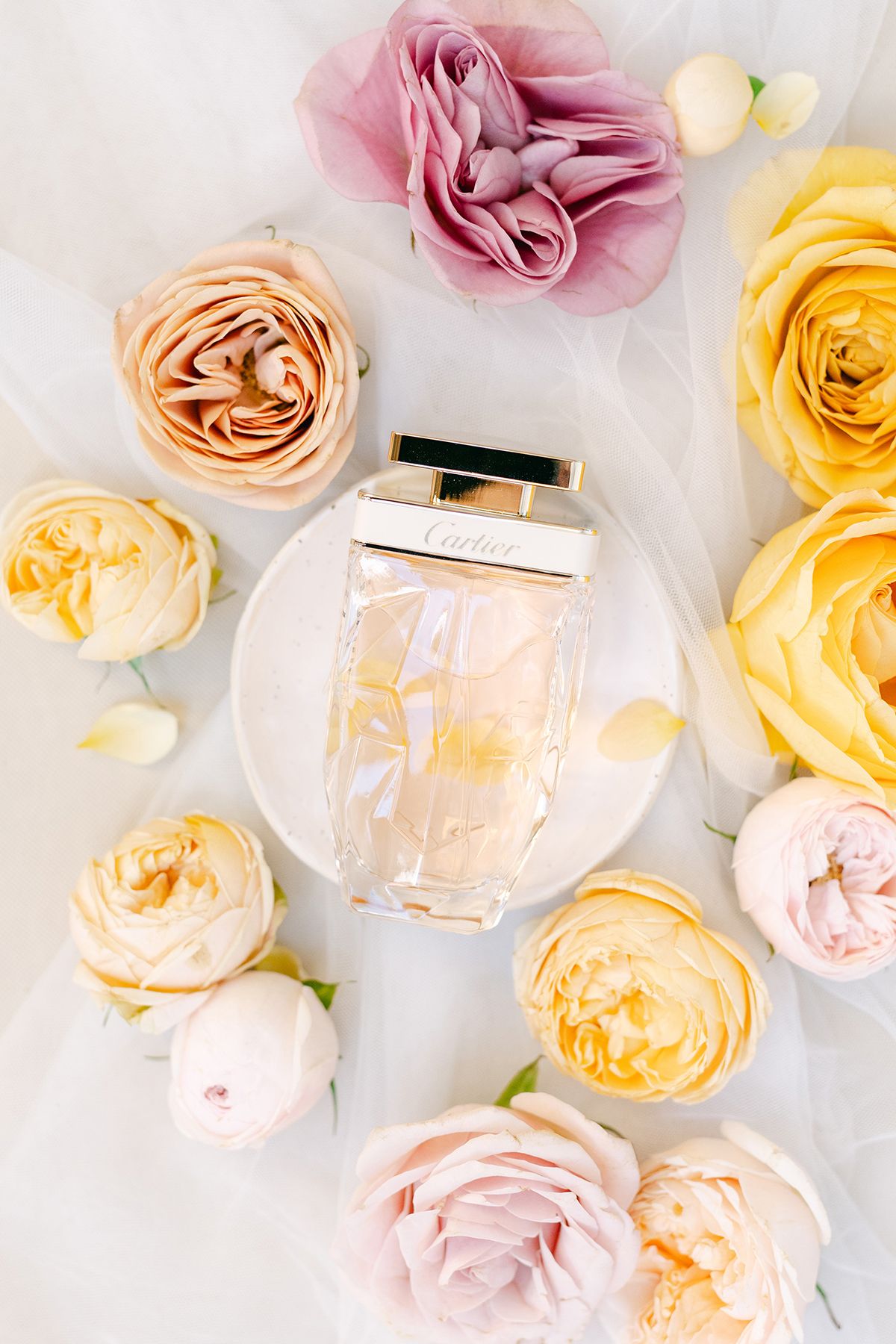 Wedding details with perfume, styled in natural light.