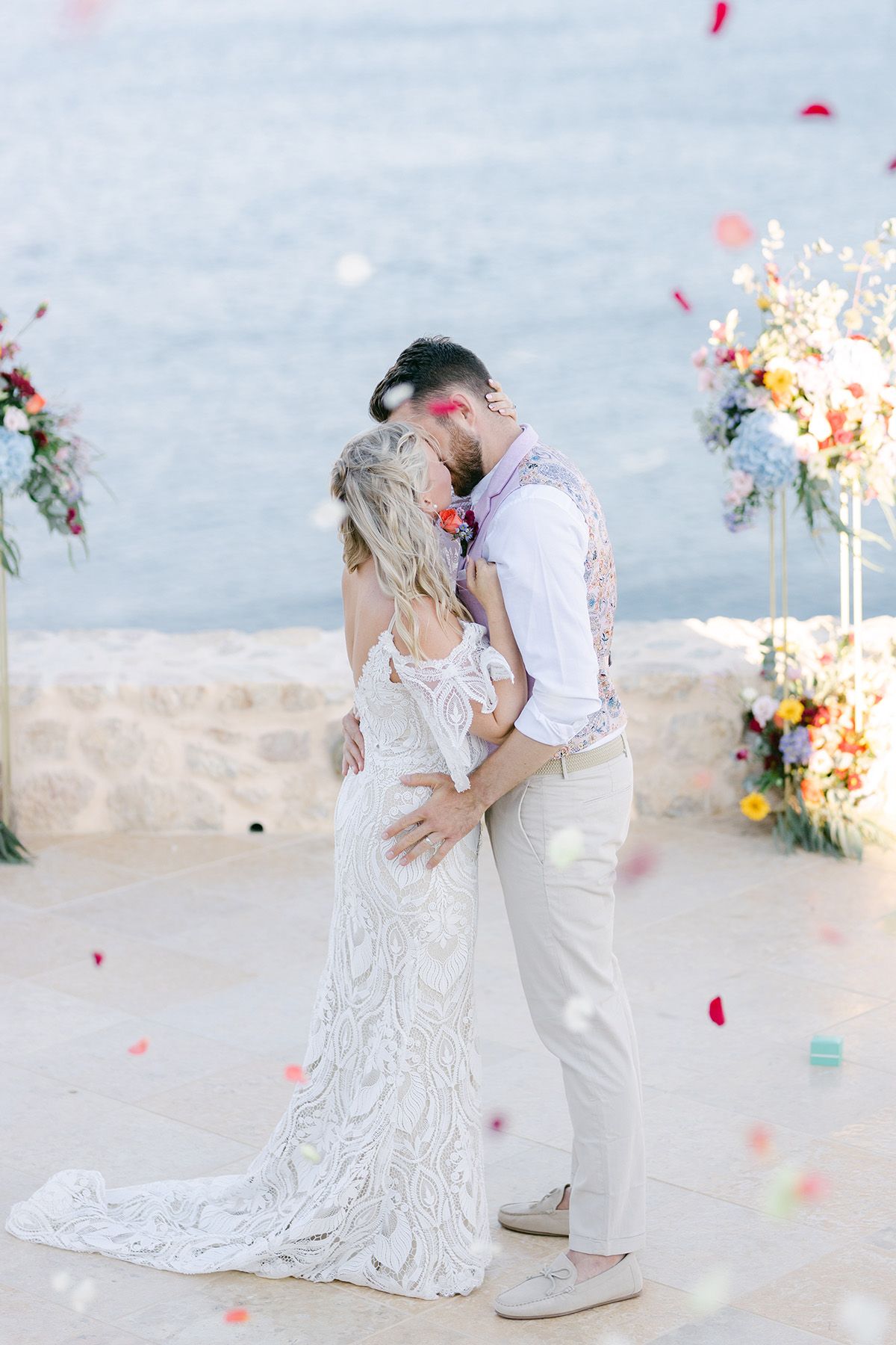 Couple portrait on Ios Island, Greece, by the sea in warm evening light.