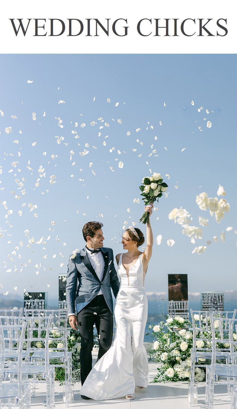 Couple portrait in Santorini, Greece, with Aegean views in soft golden light.