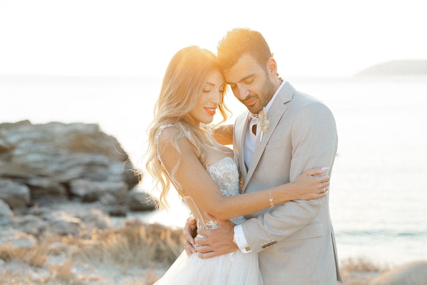 Couple portrait at sunset in Greece, photographed in an editorial style with soft golden light.